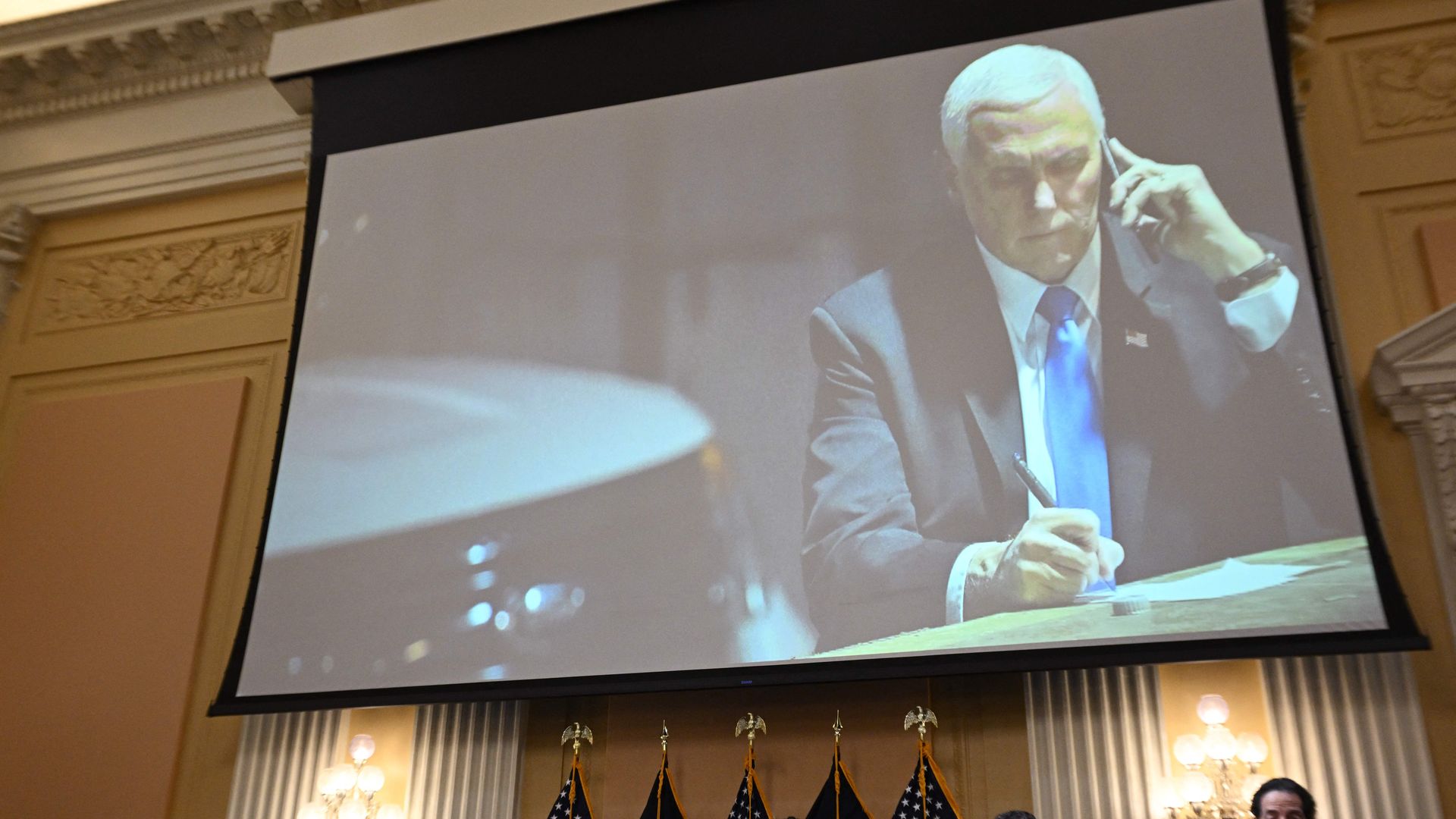 An image on a screen shows former US Vice President Mike Pence looking at his phone as he shelters in a secure underground location after being evacuated from the Senate chamber on January 6, 2021