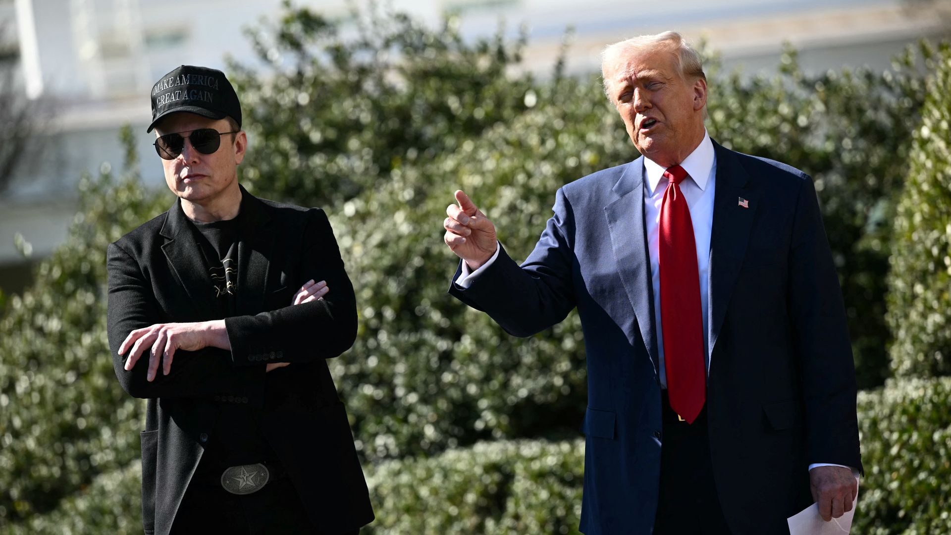 President Donald Trump and Tesla CEO Elon Musk speak to the press as they stand next to a Tesla vehicle on the South Portico of the White House on March 11, 2025 in Washington, DC. (Photo by Mandel NGAN / AFP) (Photo by MANDEL NGAN/AFP via Getty Images)