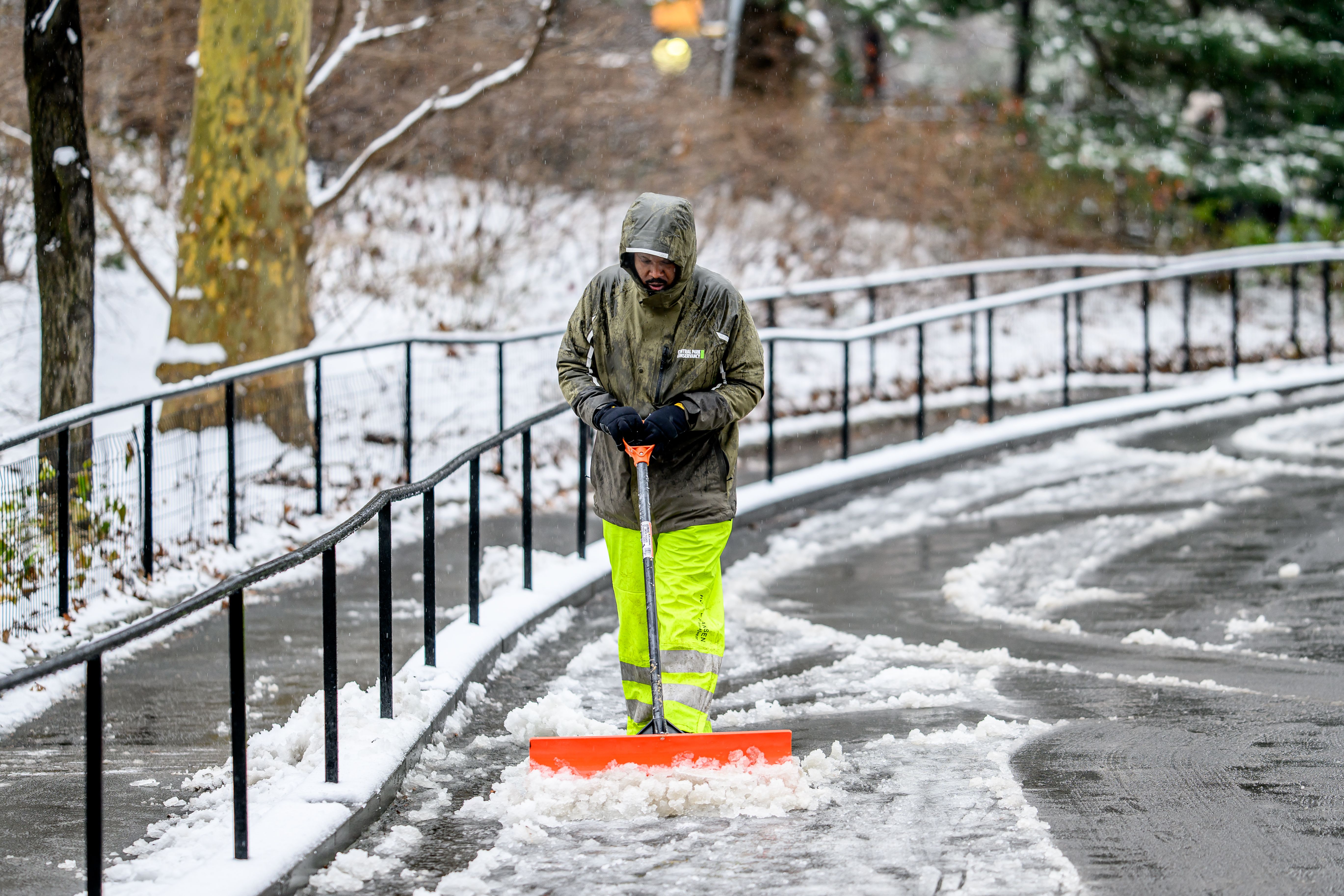  An NYC parks worker clears snow as it blankets New York City breaking two year stretch without snow on January 16, 2024 in New York City. 