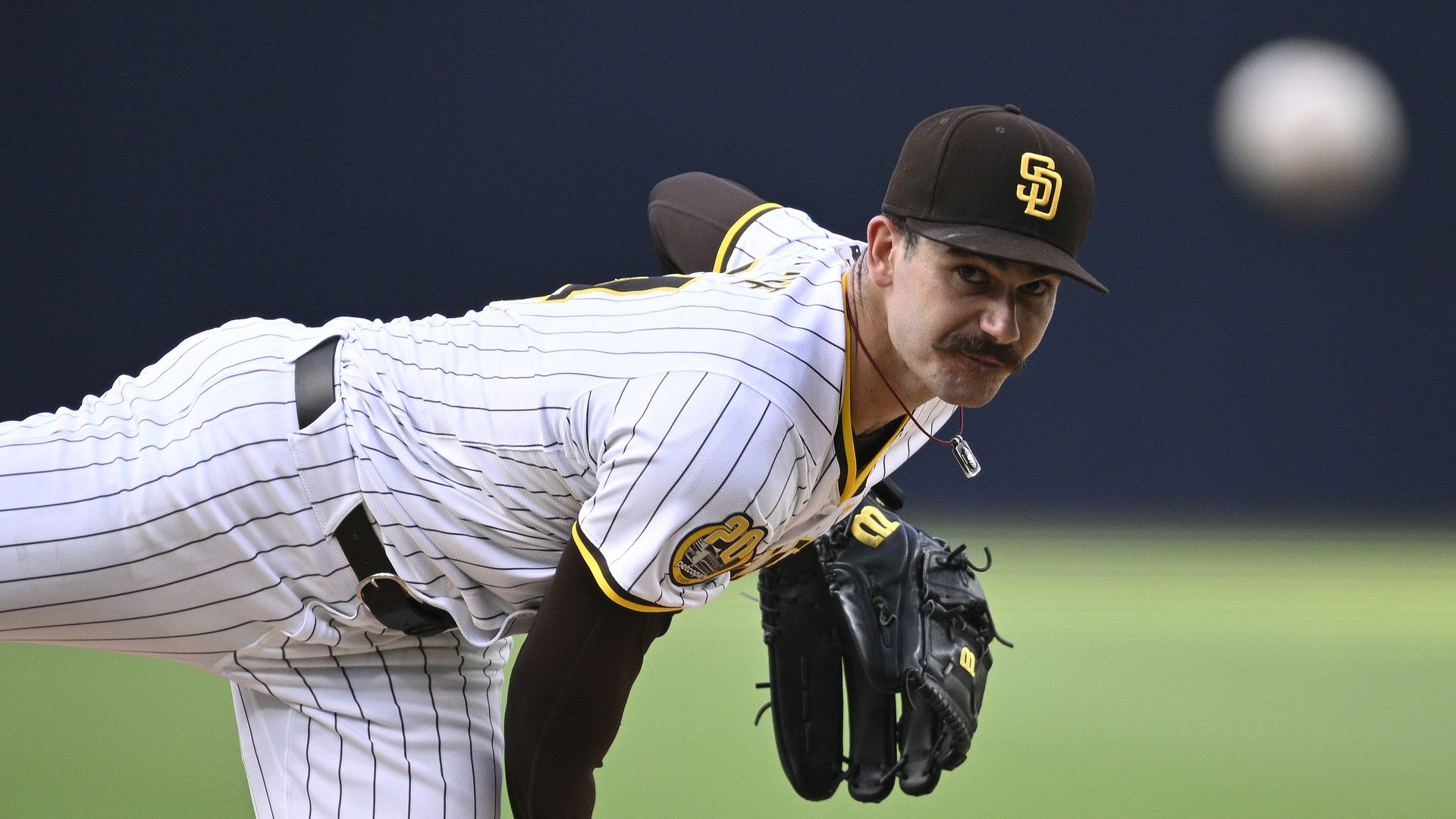 Dylan Cease delivers a pitch in the Padres white pinstrips