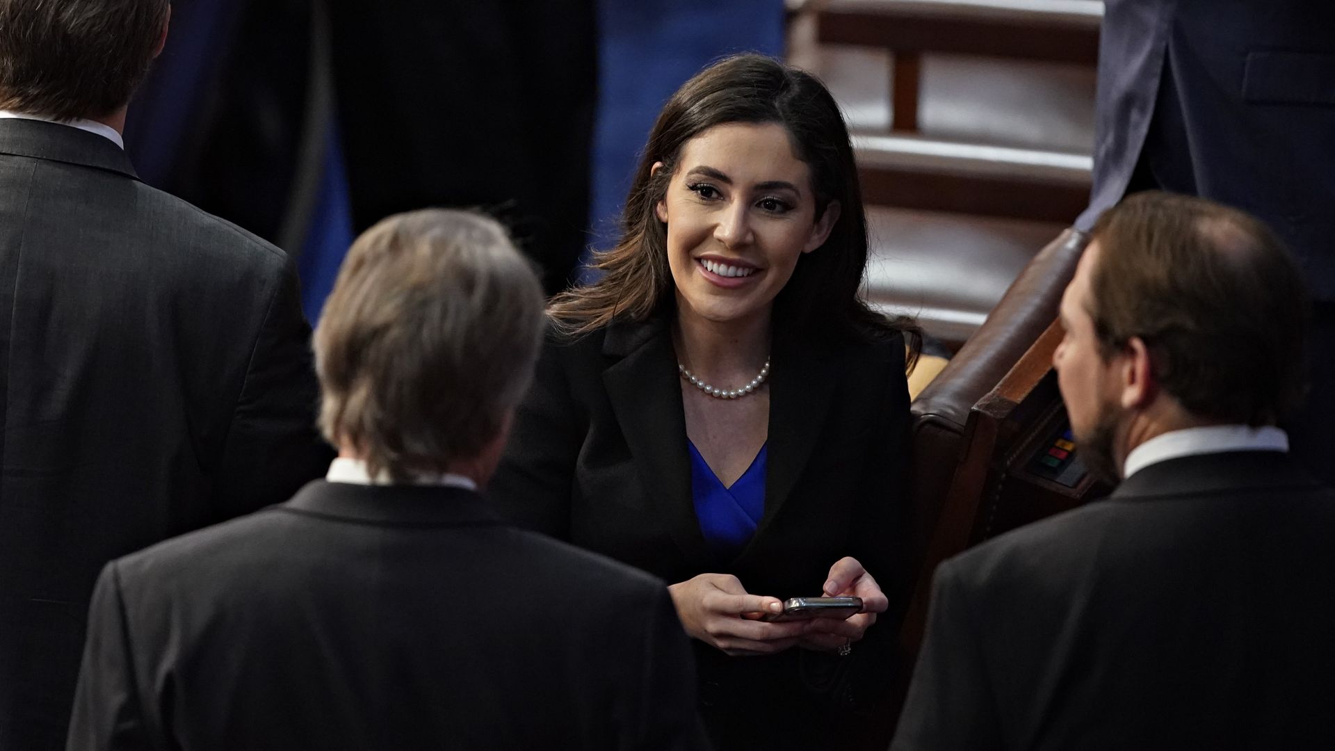 Rep. Anna Paulina Luna, wearing a blue dress, black blazer and pearl-shaped necklace, speaks to colleagues on the House floor.