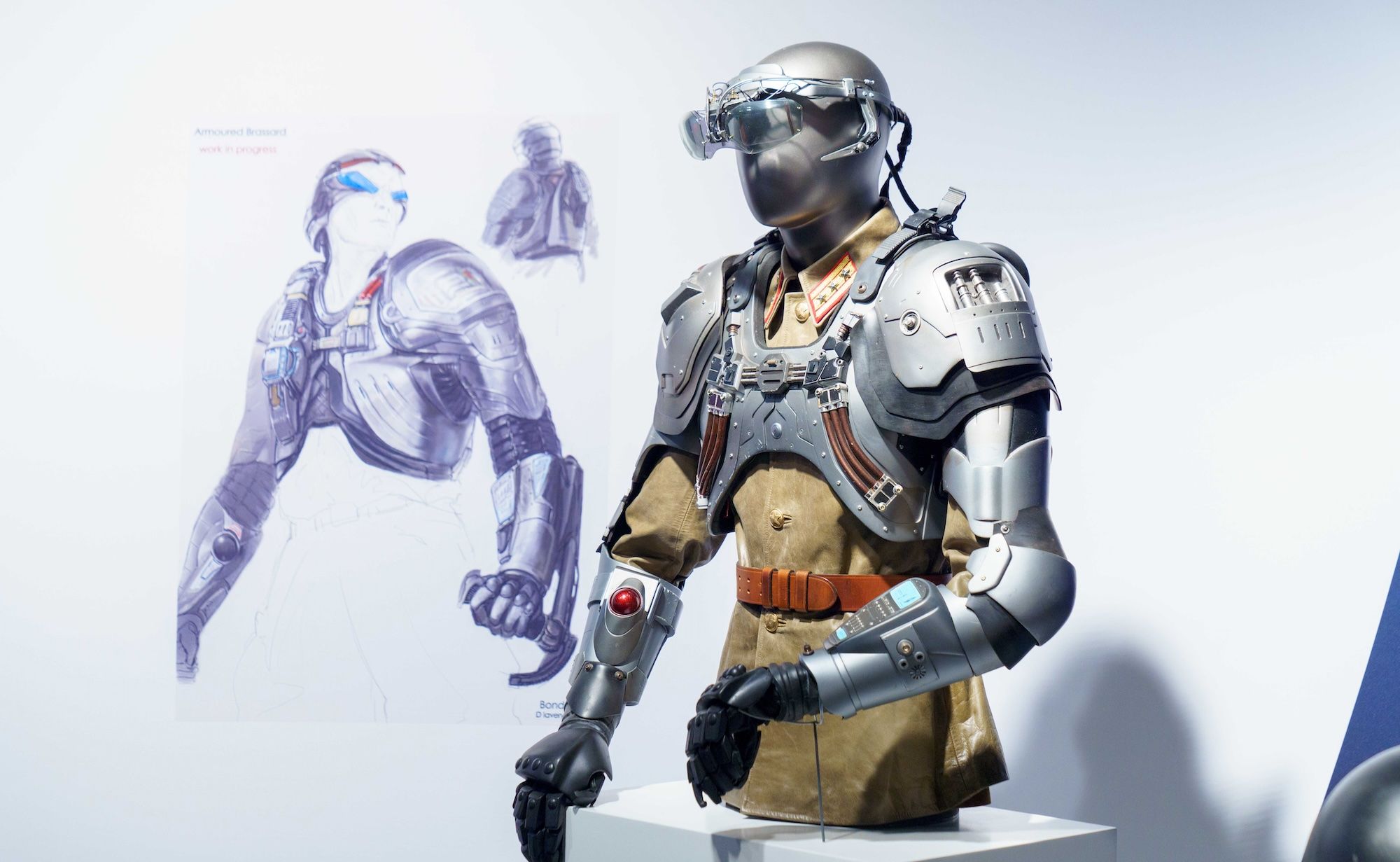 Drawing of a robotic metal contraption and a mannequin wearing it.