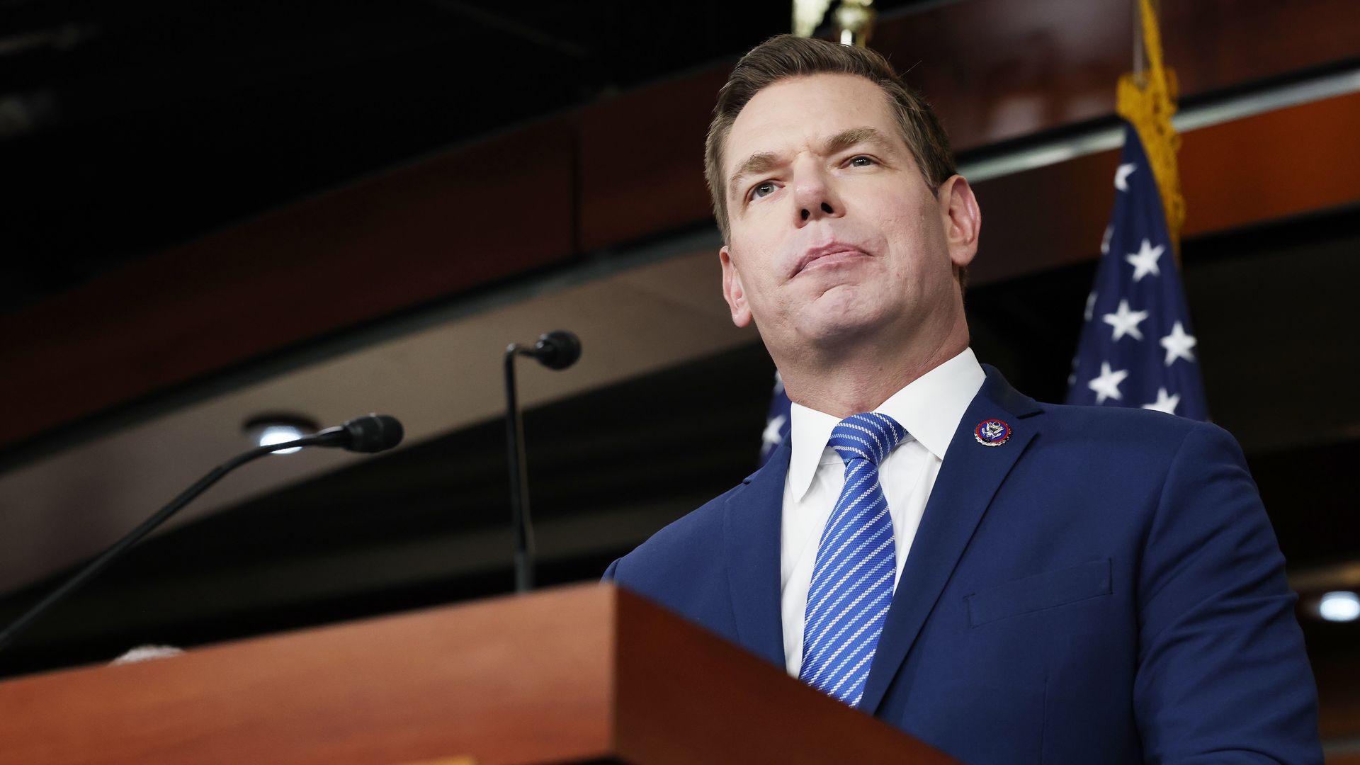 Swalwell wearing a blue suit jacket, white shirt and blue striped tie