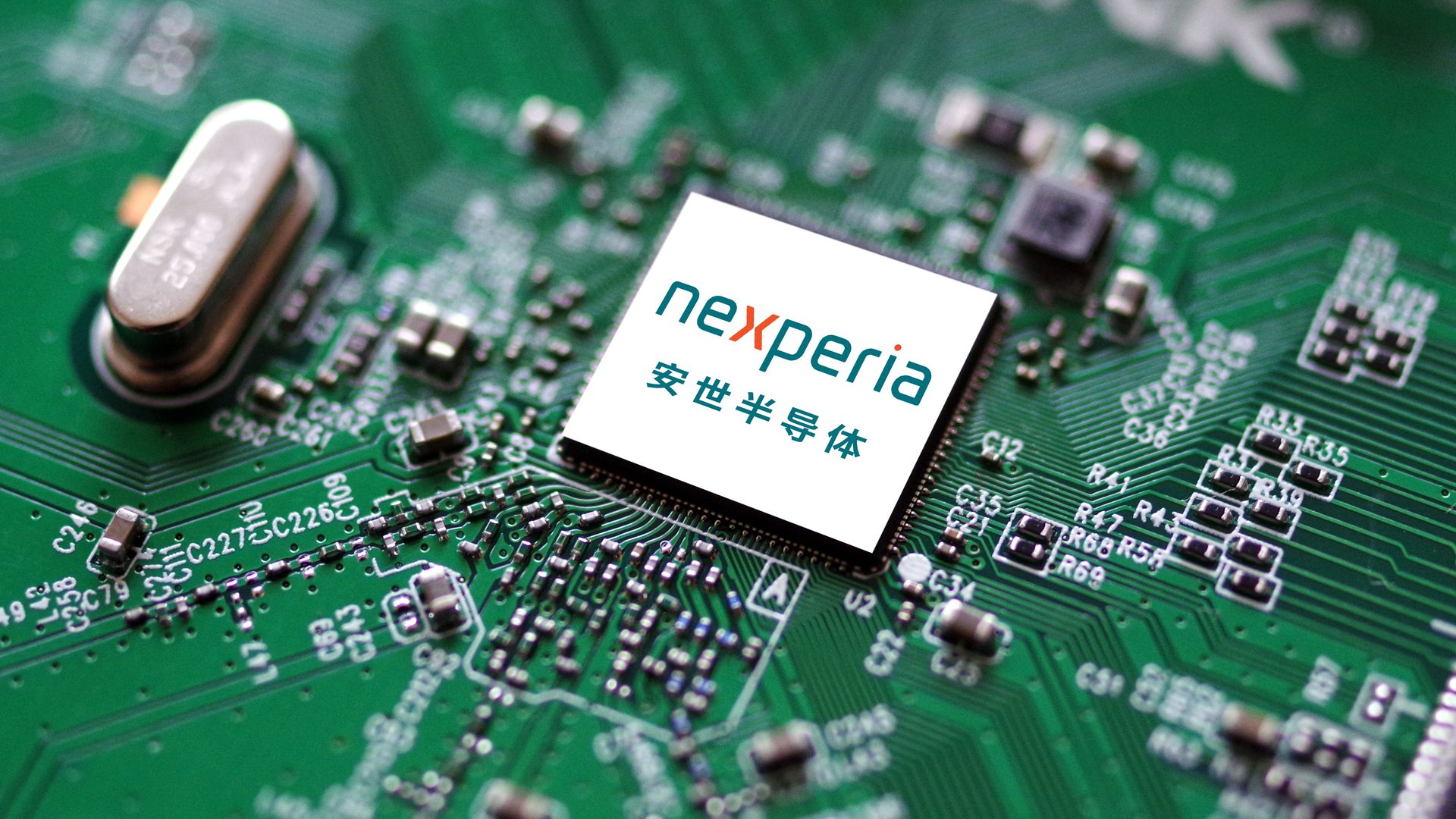 Close-up of a green circuit board with a white microchip labeled "nexperia" and Chinese characters, surrounded by electronic components and circuit traces.