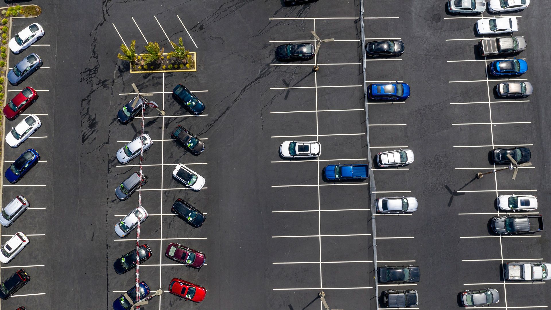 A mostly empty car lot, as viewed from above