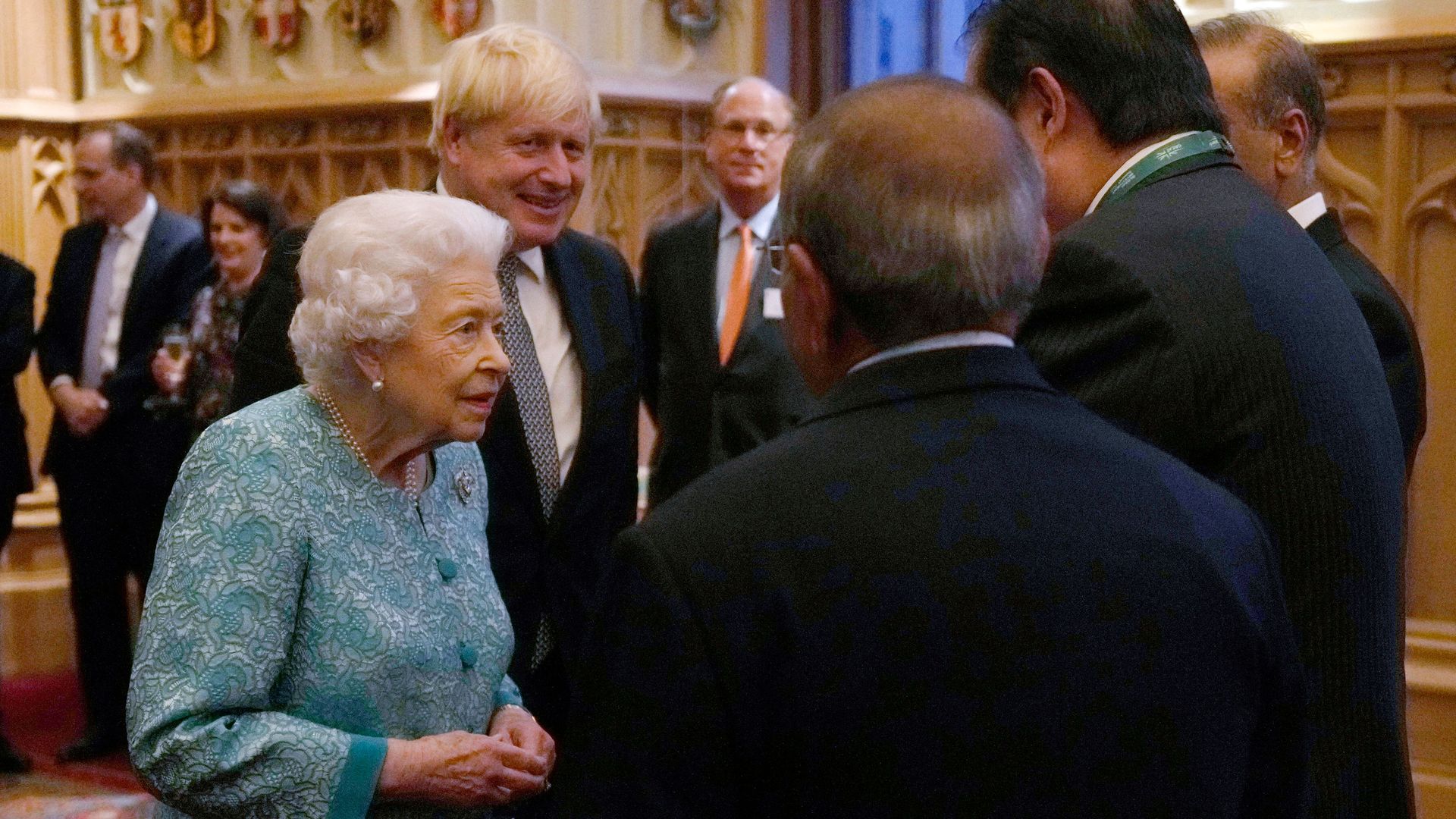 Photo of Queen Elizabeth II and Boris Johnson greeting guests inside Windsor Castle