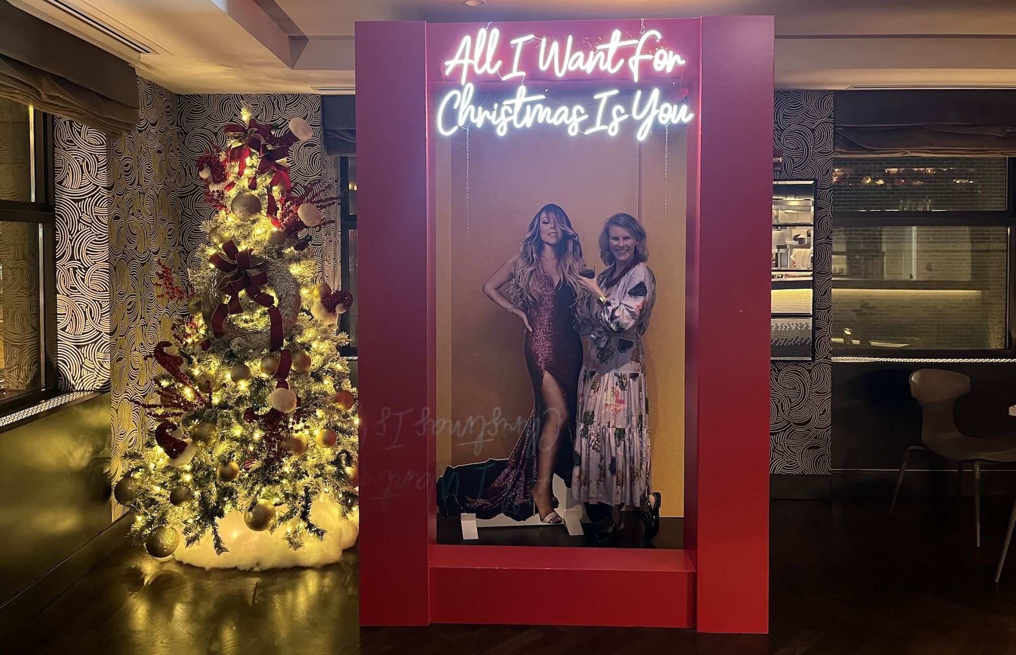 Photo of a woman posing with a cardboard cut out at a party 