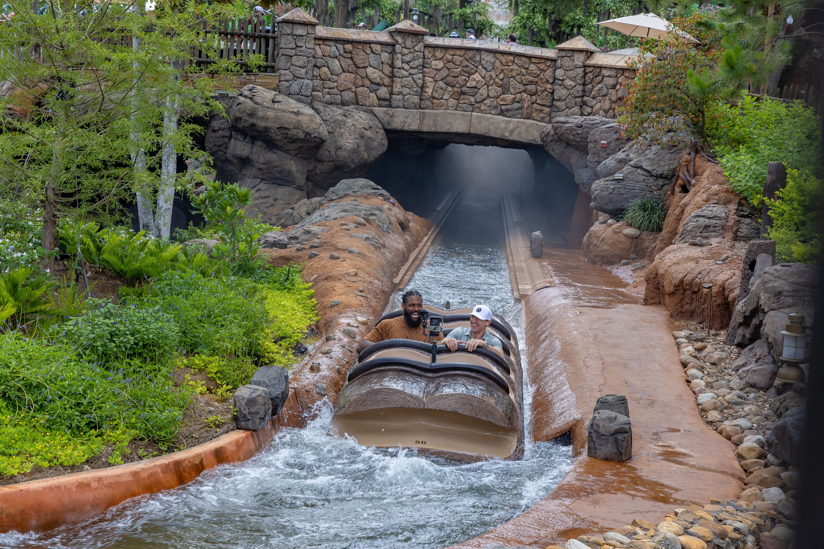 Photo shows Cam Jordan and Drew Brees riding Tiana's Bayou Adventure.