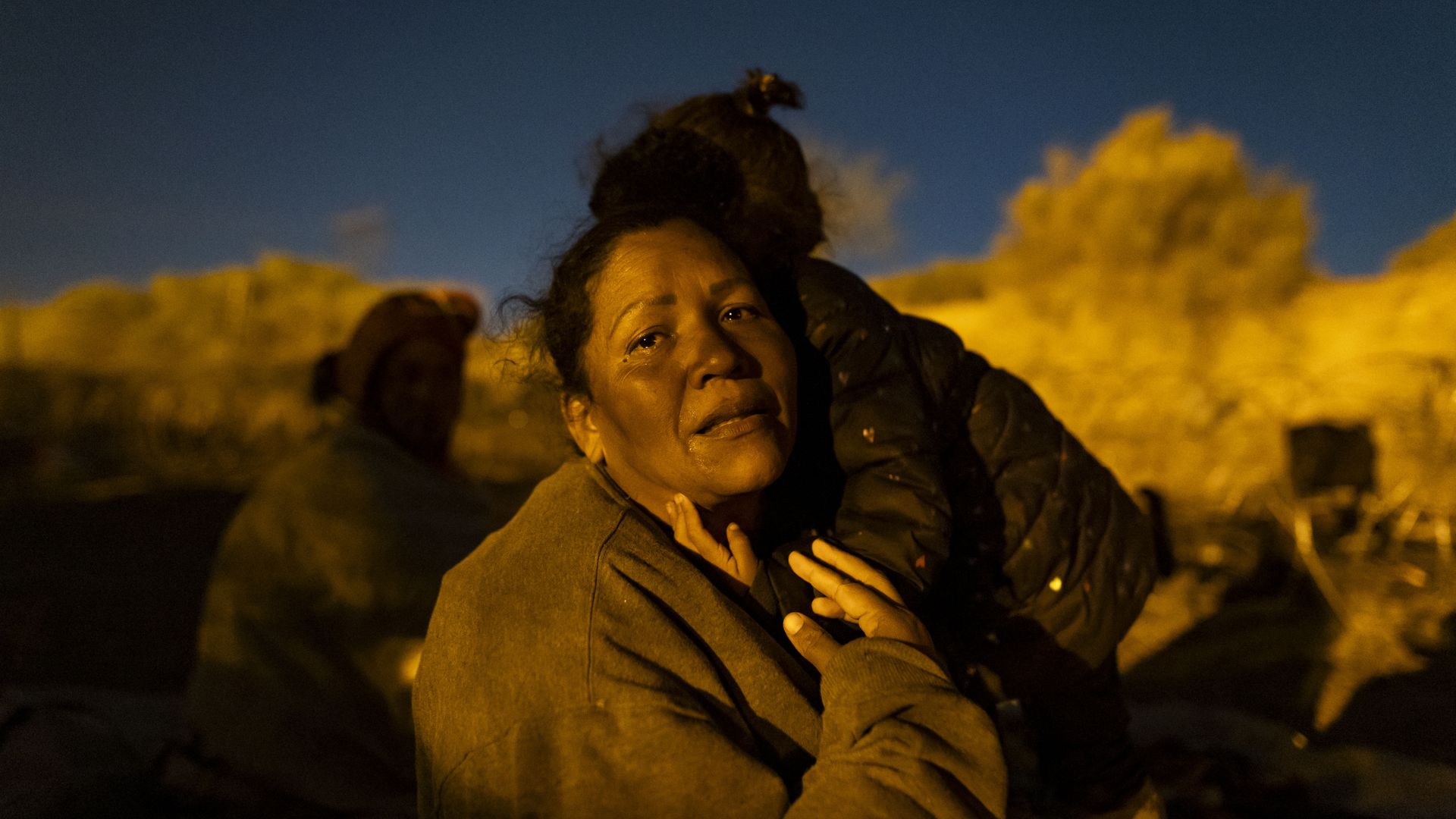 A migrant woman from Venezuela is comforted by her daughter as she cries while retelling her journey to reach El Paso, Texas, on April 2, 2024..