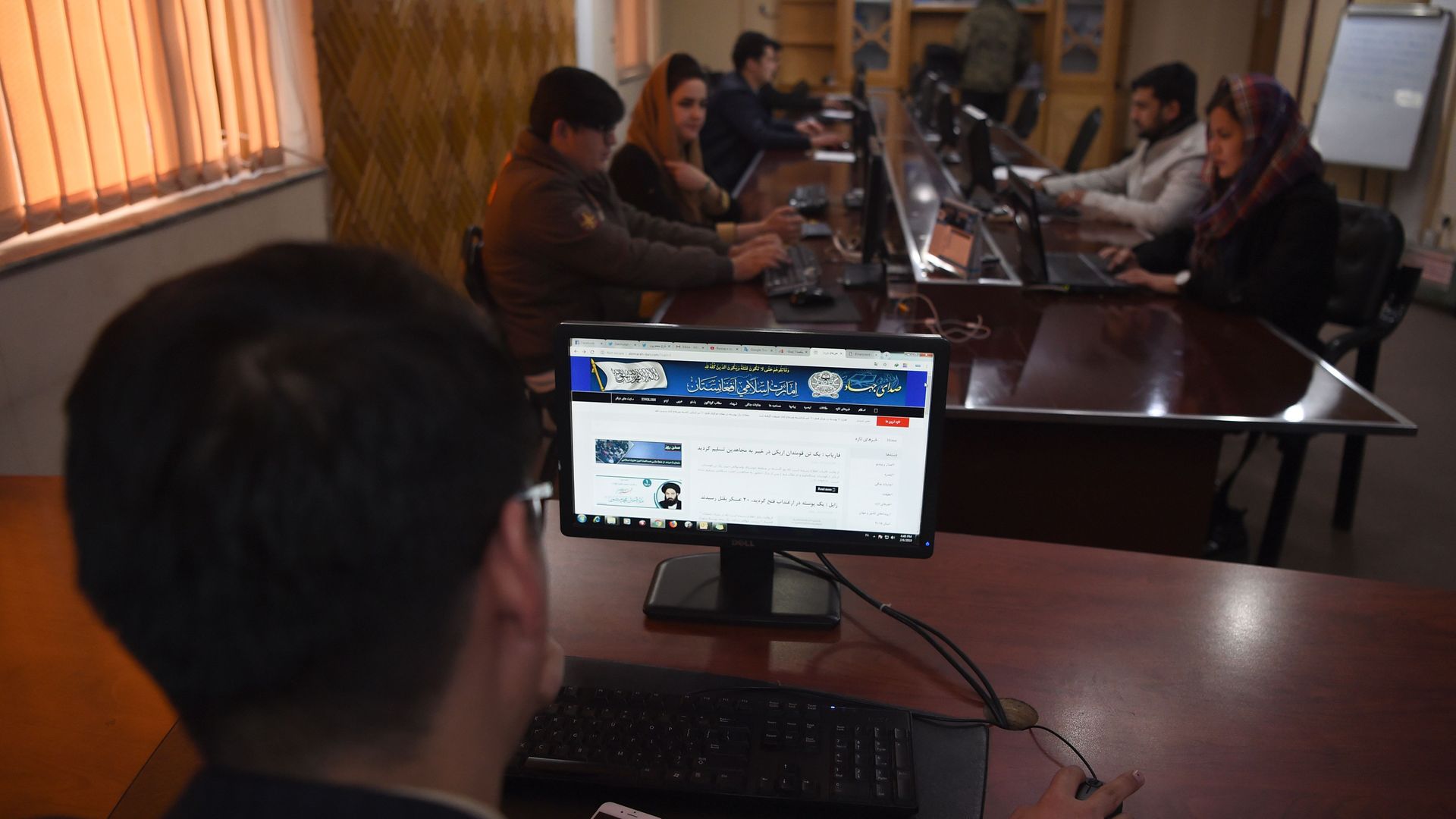 A man browses the Taliban's website in the newsroom at Maiwand TV station in Kabul