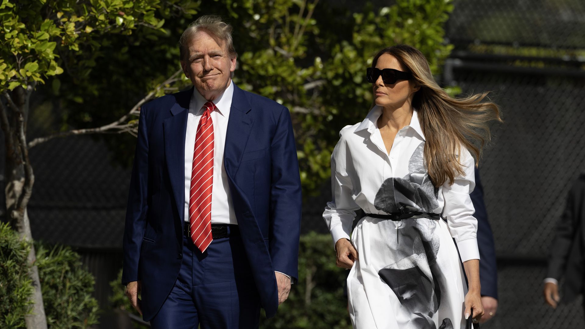 Donald Trump and former first lady Melania Trump walk together as they prepare to vote at a polling station setup in the Morton and Barbara Mandel Recreation Center