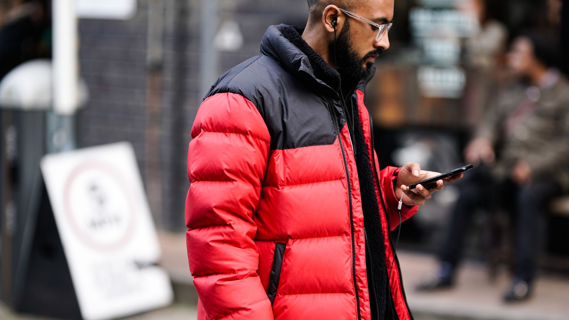 Man carries cell phone.