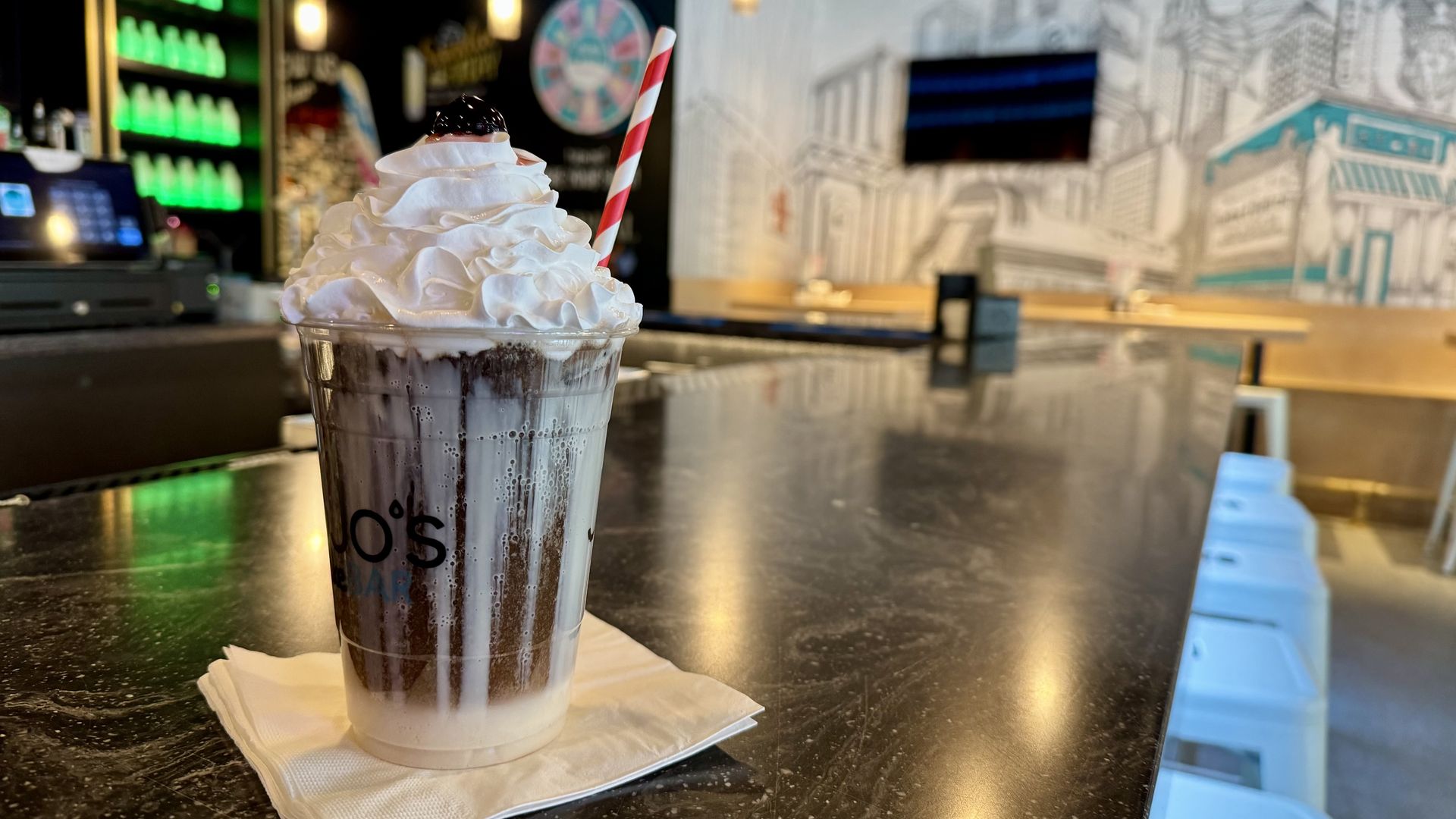 Soda topped with whipped cream and a cherry.