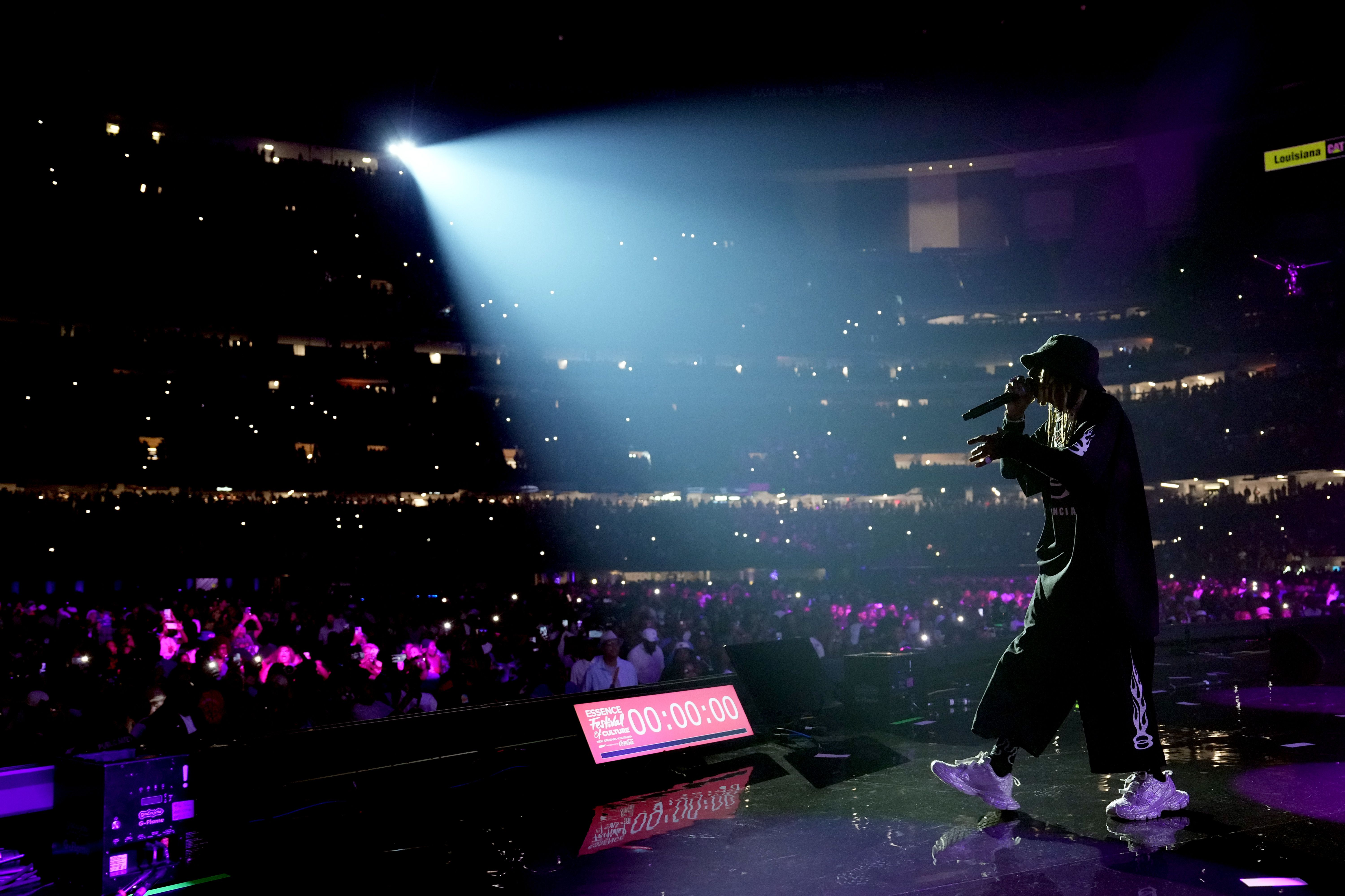 Photo shows Lil Wayne performing at Essence Fest.