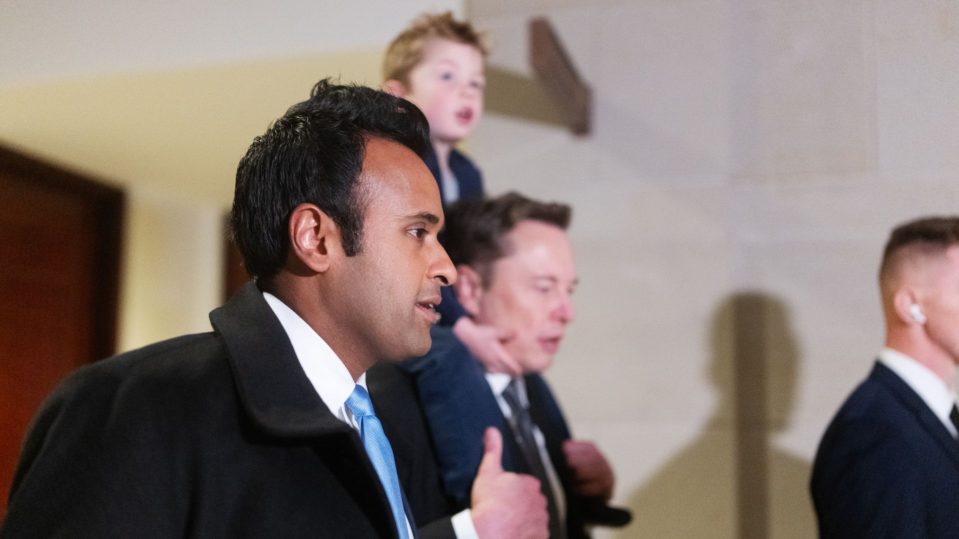 Vivek Ramaswamy and Elon Musk (carrying his son X on his shoulders) in the halls of the U.S. Capitol.