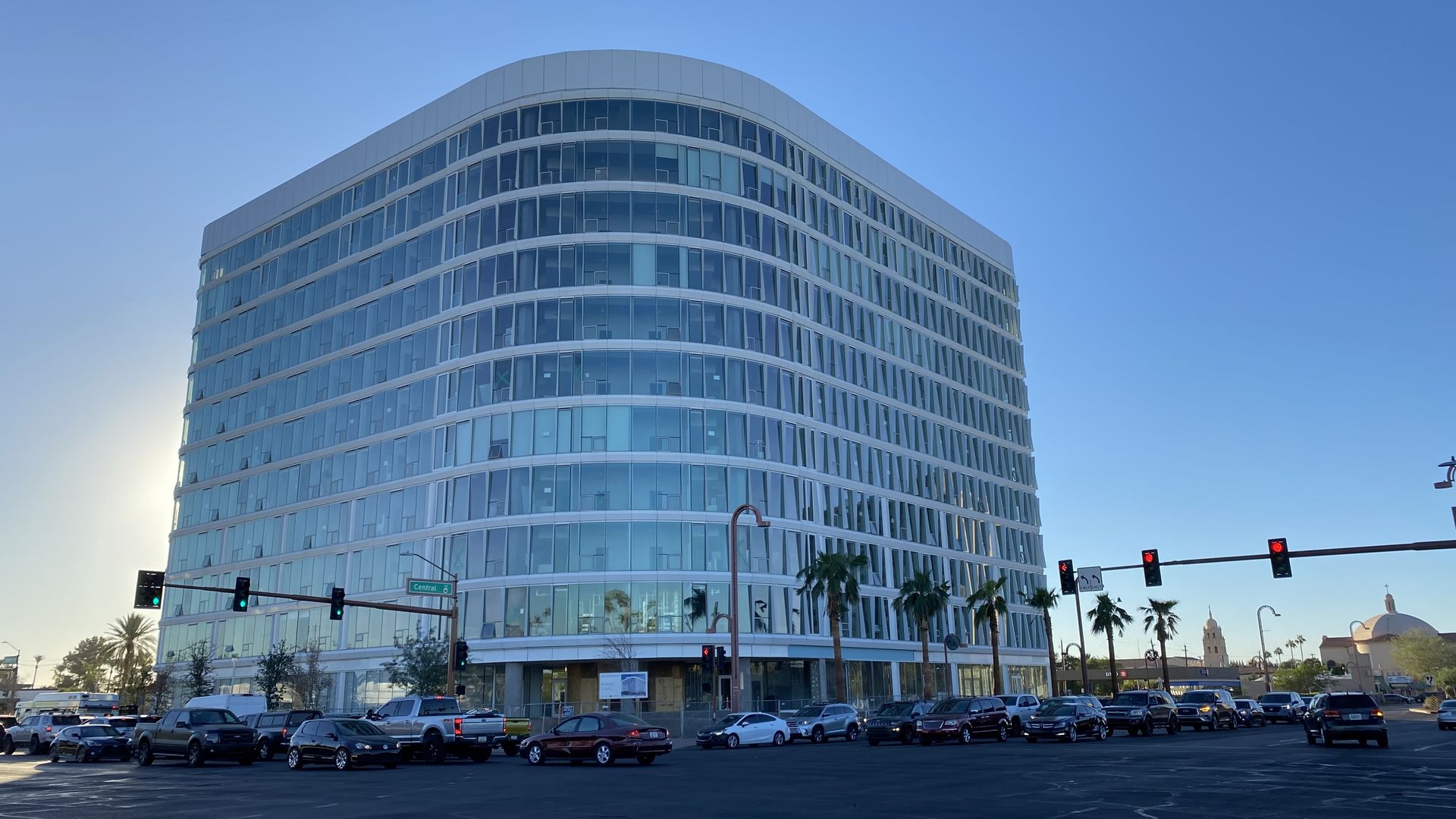 An office building with a rounded corner facing an intersection. 