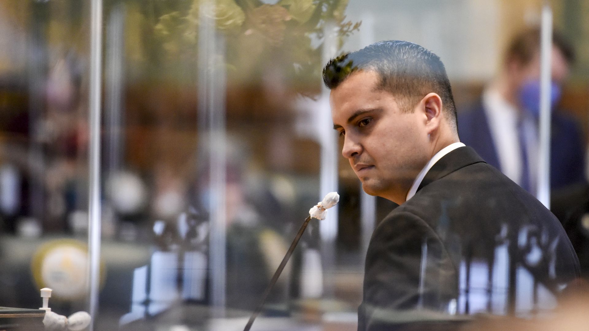 A photo of Dave Williams speaking on a microphone.