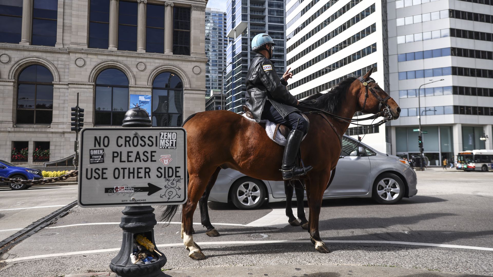 Photo of a police officer on a horse in street traffic 