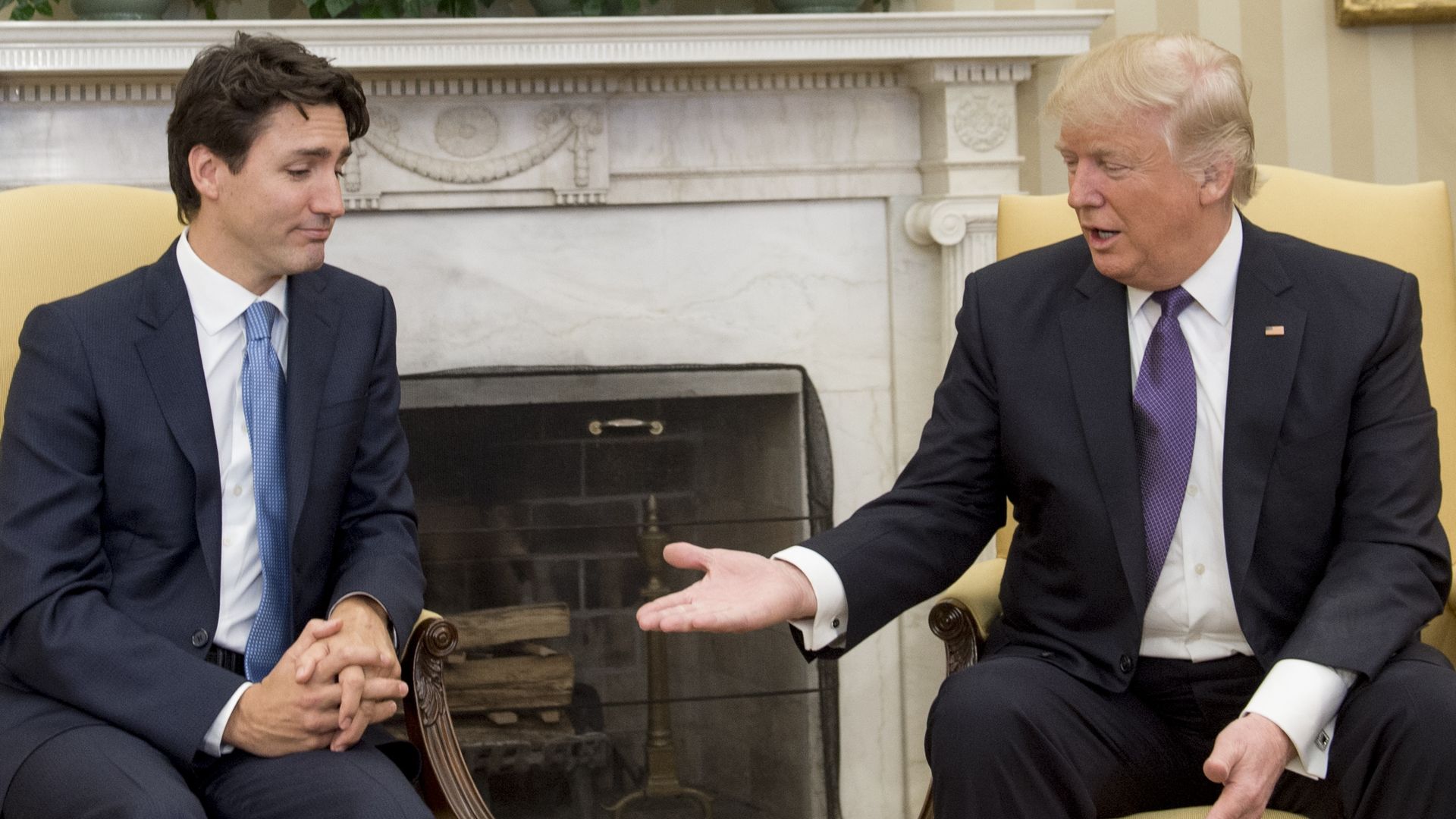 US President Donald Trump and Canadian Prime Minister Justin Trudeau shake hands during a meeting in the Oval Office 