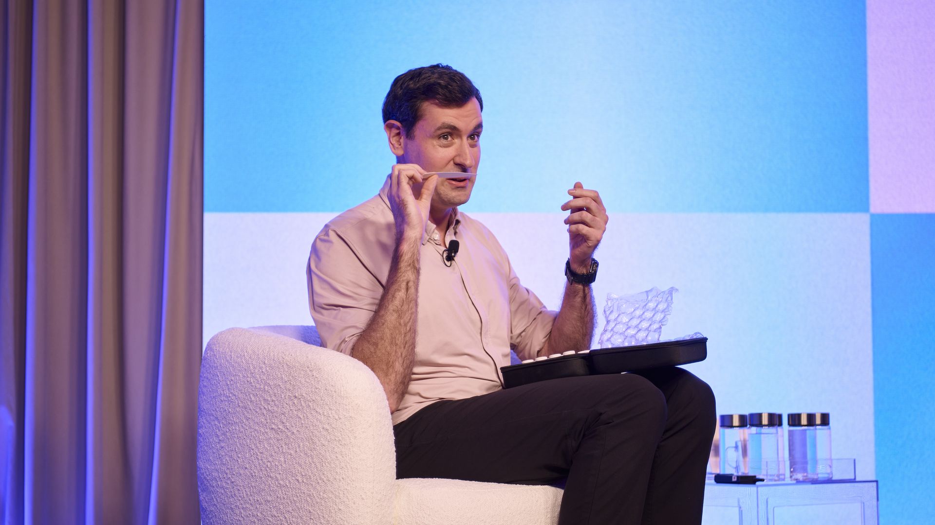 photo of Osmo CEO Alex Wiltschko on stage, smelling a scent on a paper 