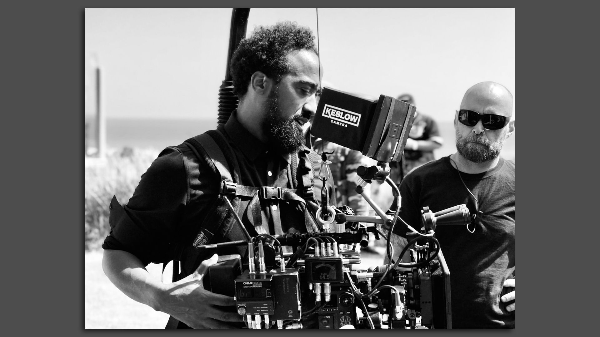 Tommy Maddox-Upshaw, a cinematographer from Mattapan, center, works camera equipment.