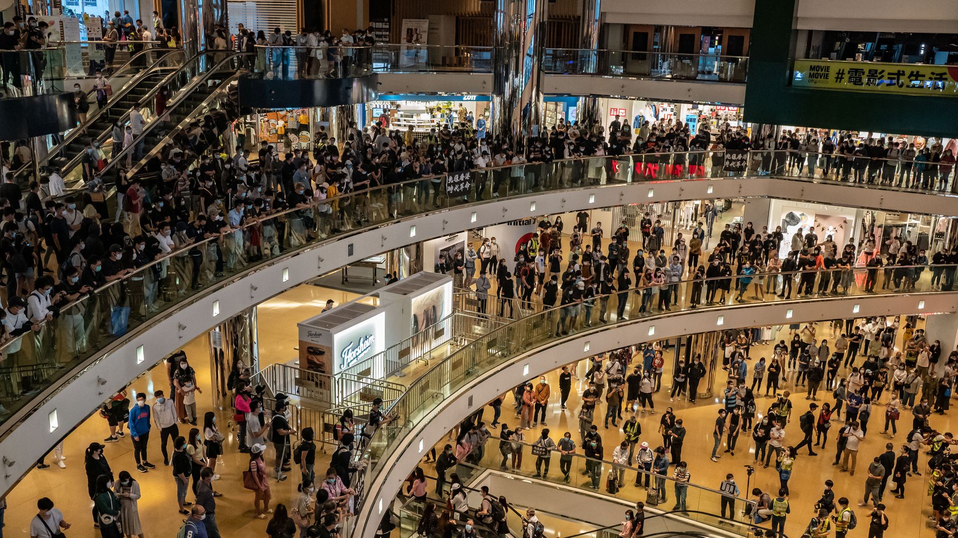 This image shows large crowds standing in a mall