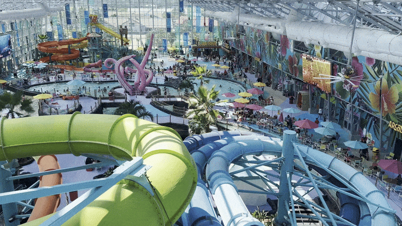 Image shows an indoor water park with slides