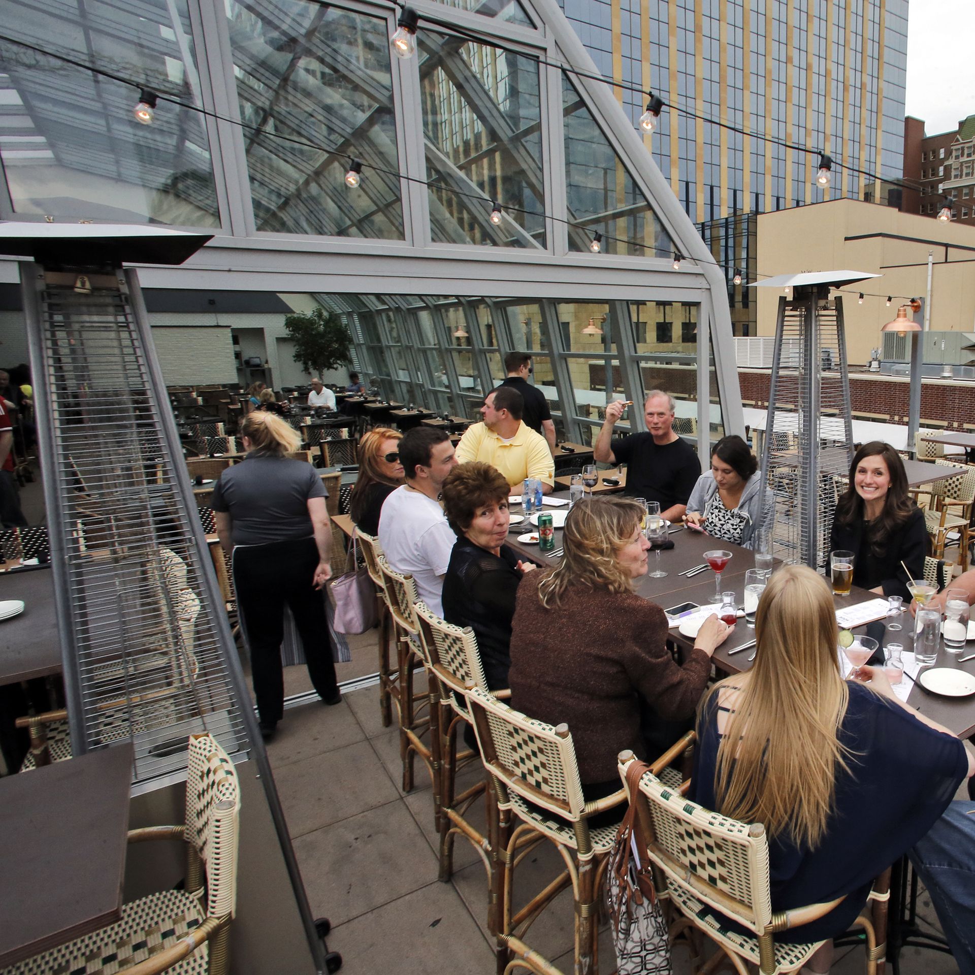 People dine and drink on a rooftop