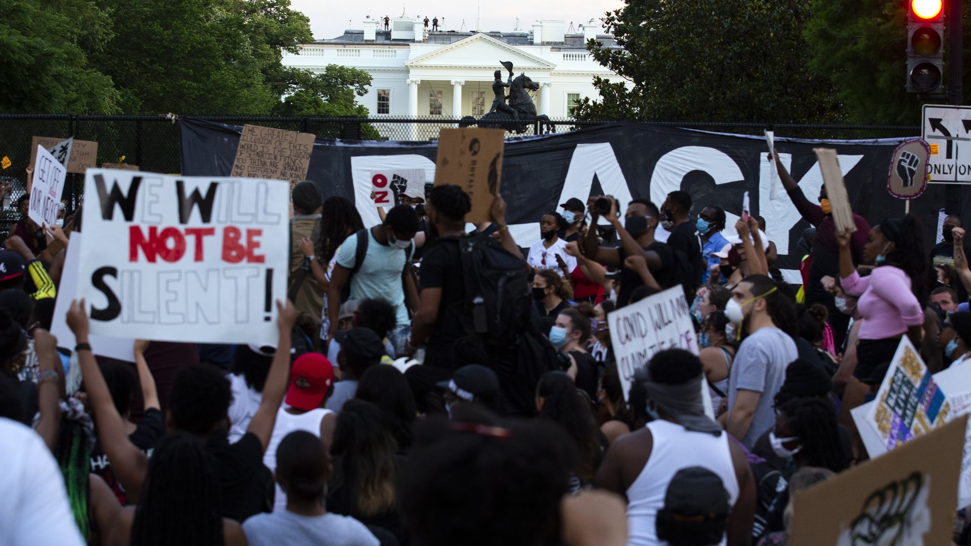 Protesters gather north of Lafayette Square near the White House during a demonstration against racism and police brutality, in Washington, DC 