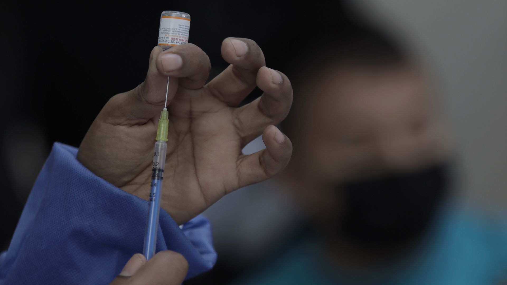 Medical staff prepares a syringe.