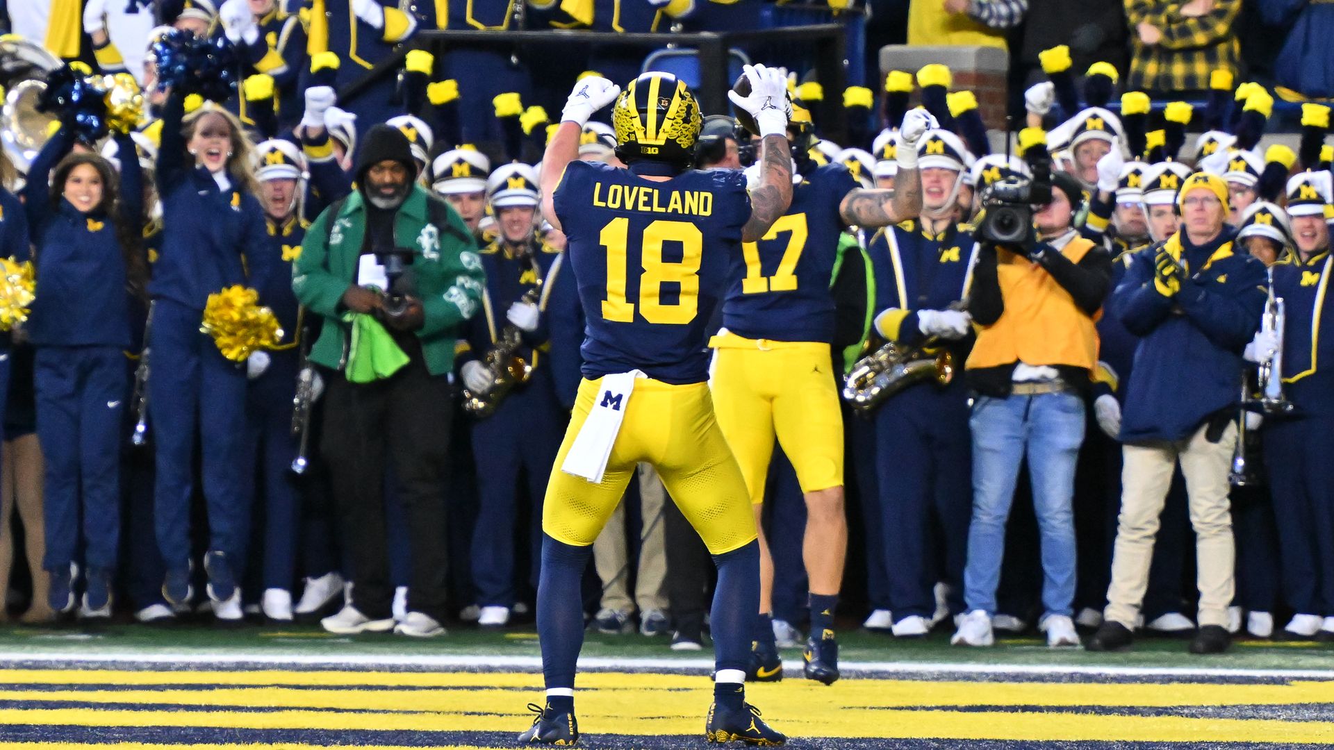 Photo of a football player celebrating in the endzone. 