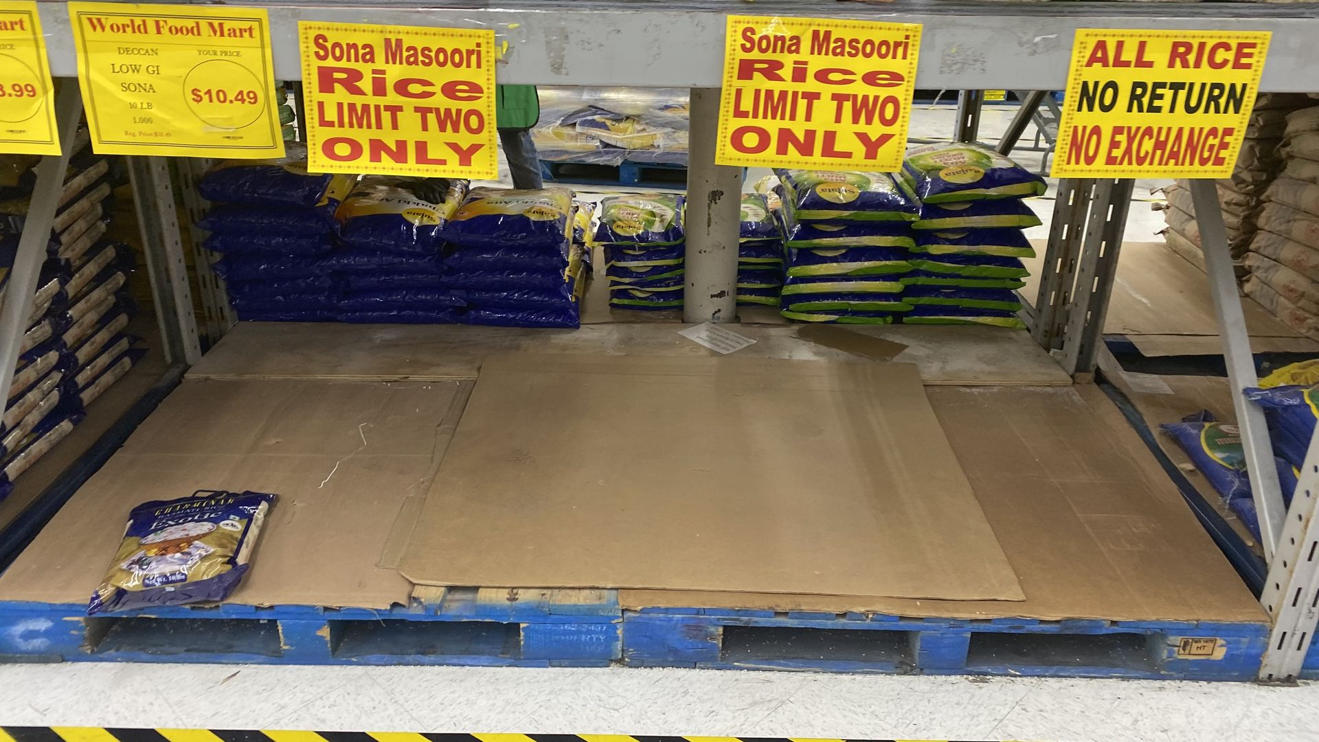 Photo of a "limit two" sign for rice. 