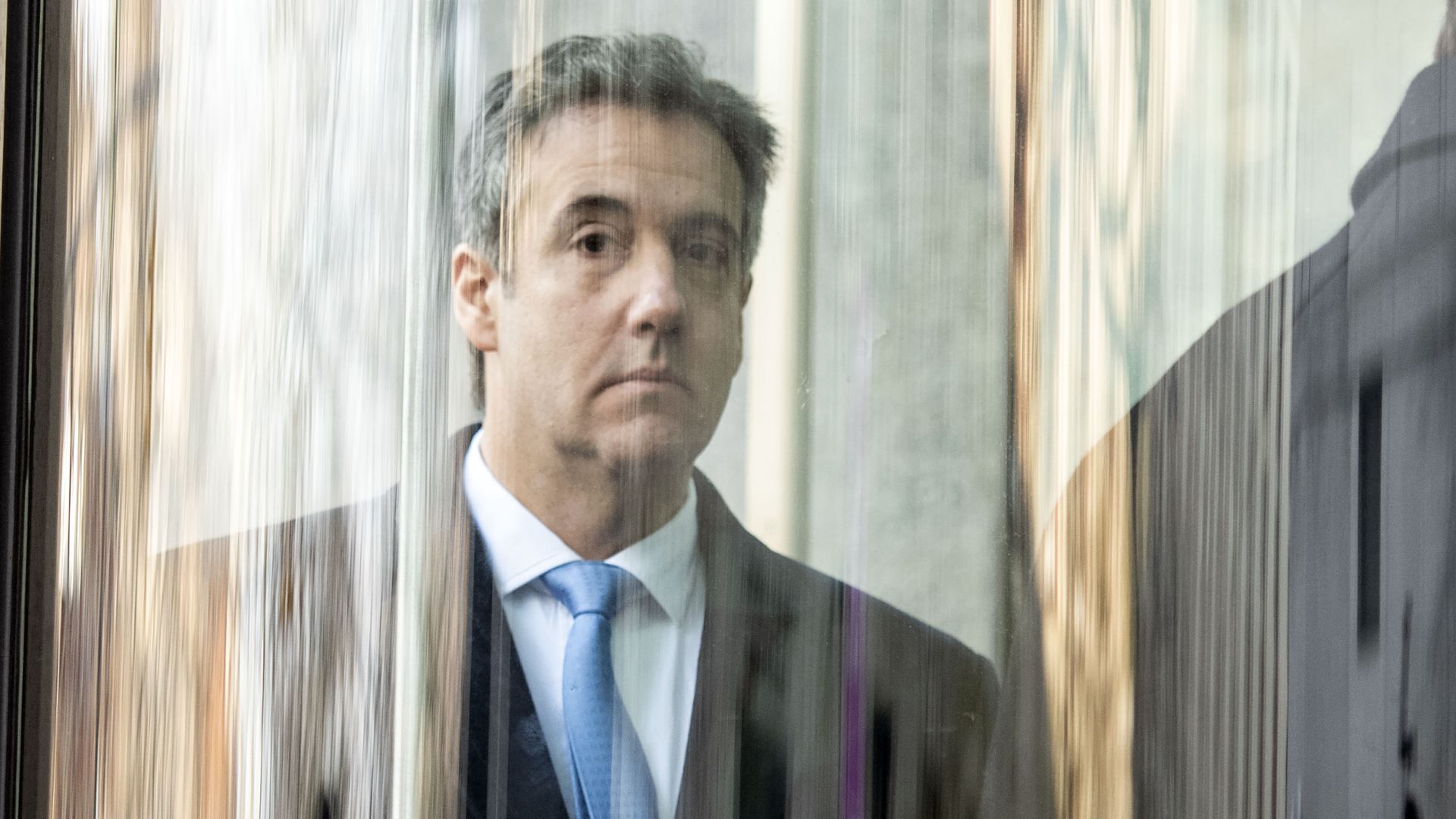 Michael Cohen behind glass