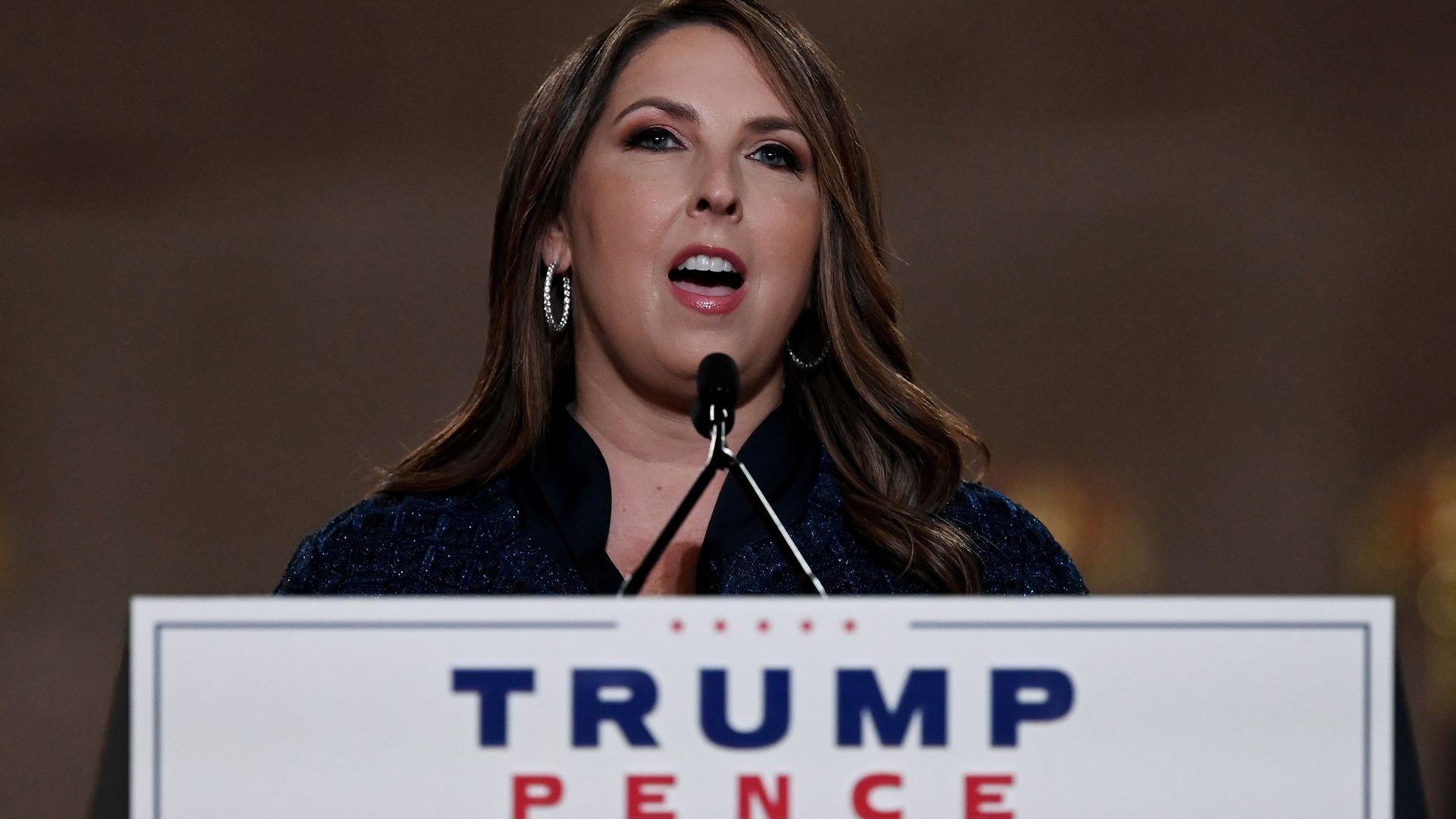 Ronna McDaniel speaks in front of a microphone