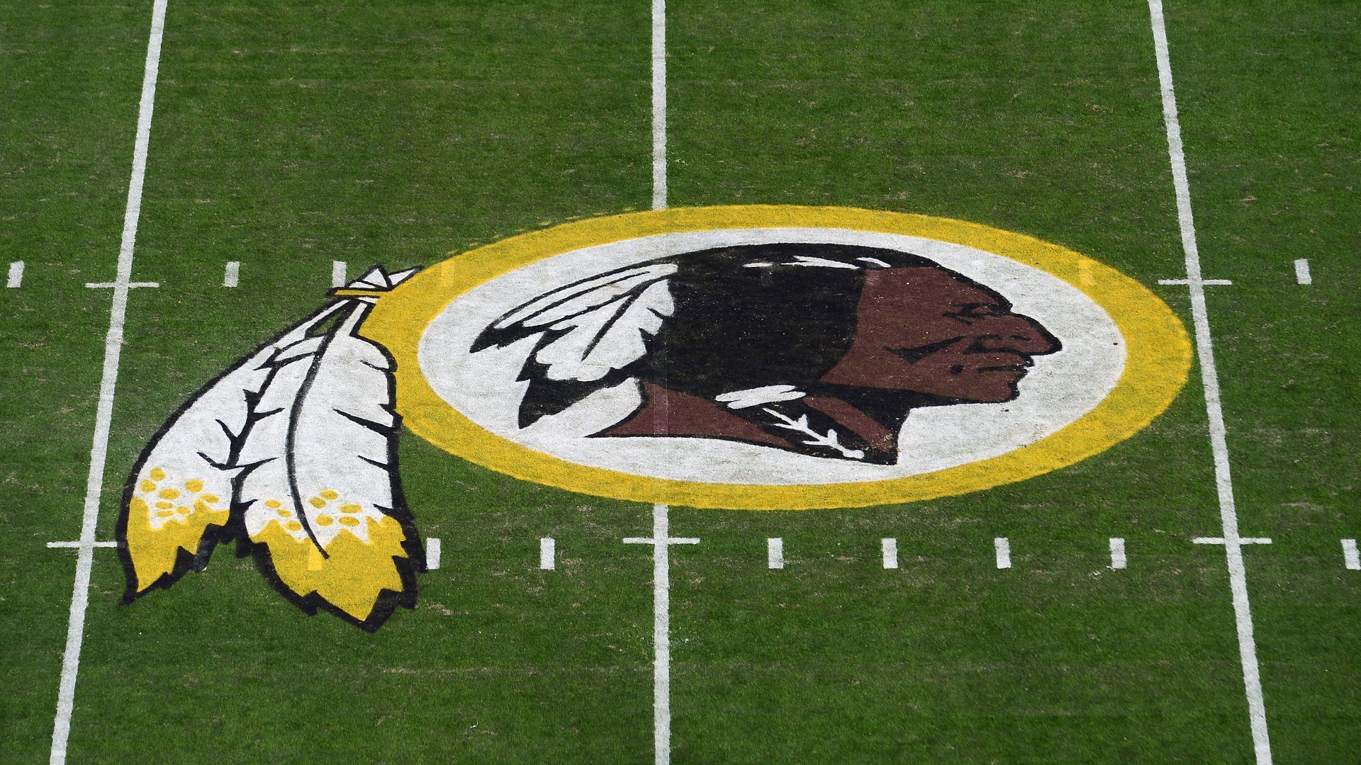 The Redskins logo on a field.
