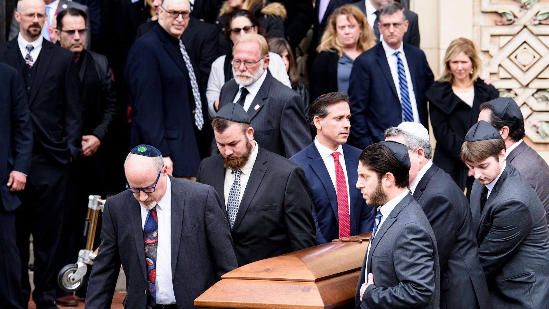 Pallbearers carry a casket from Rodef Shalom Congregation after a funeral for Cecil Rosenthal and David Rosenthal in Pittsburgh.