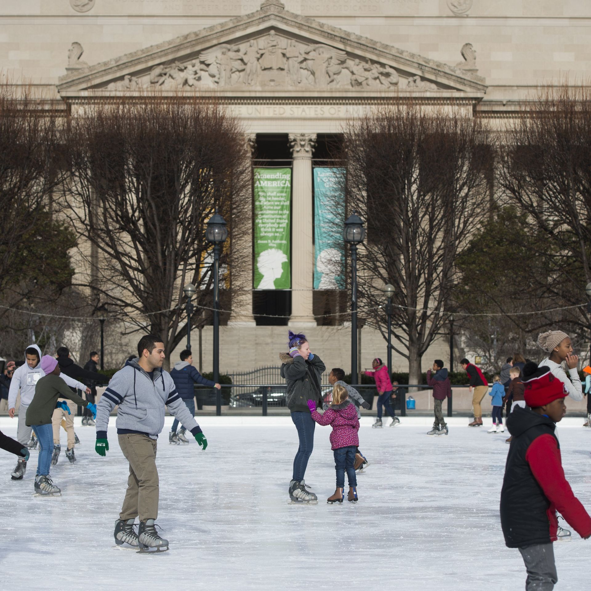 People ice skate at the National Gallery of Art Sculpture Garden ice rink.