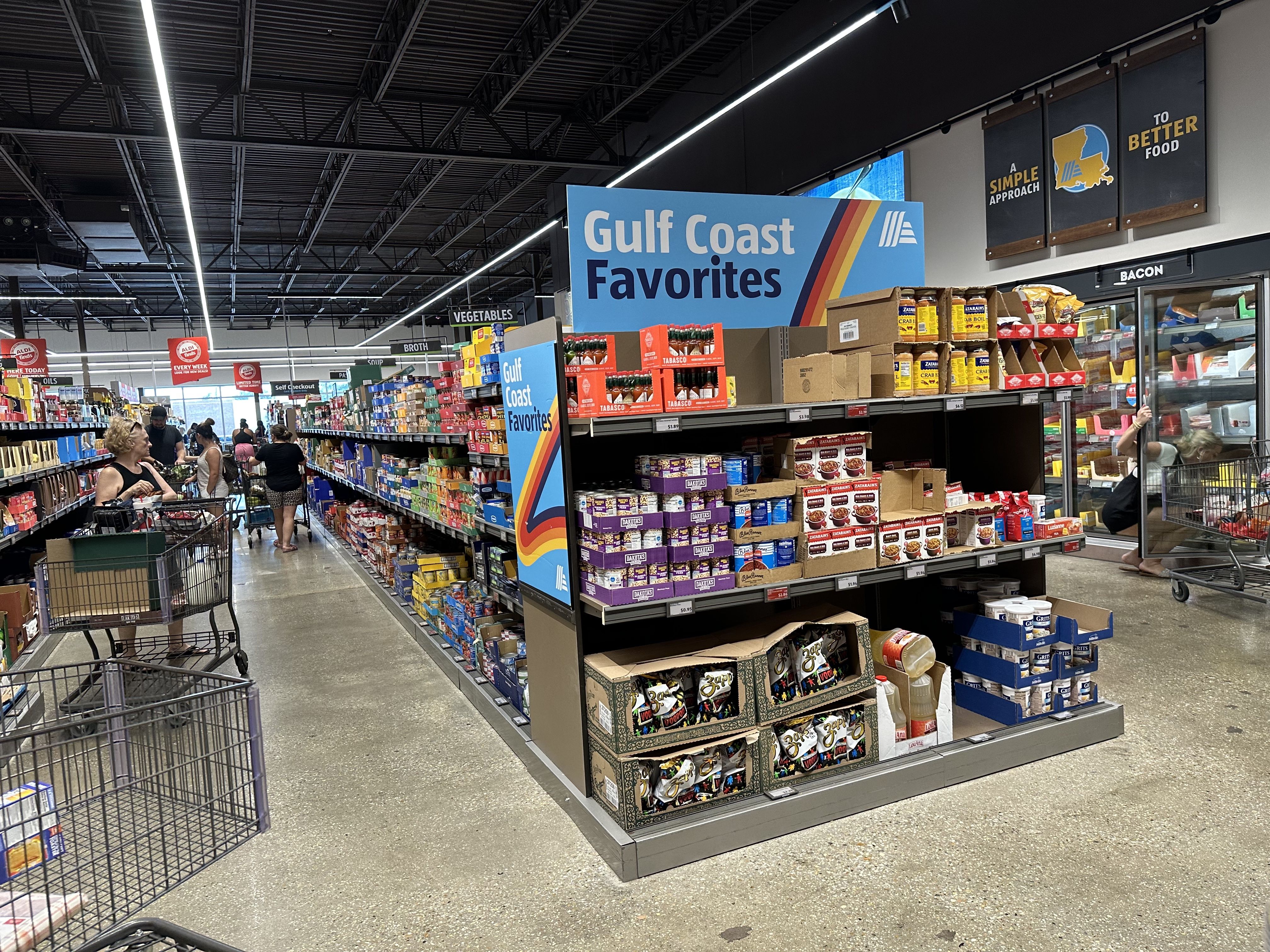 An Aldi aisle end cap is filled with locally-produced items, like Zatarain's boxes, Blue Runner red beans and Tabasco.