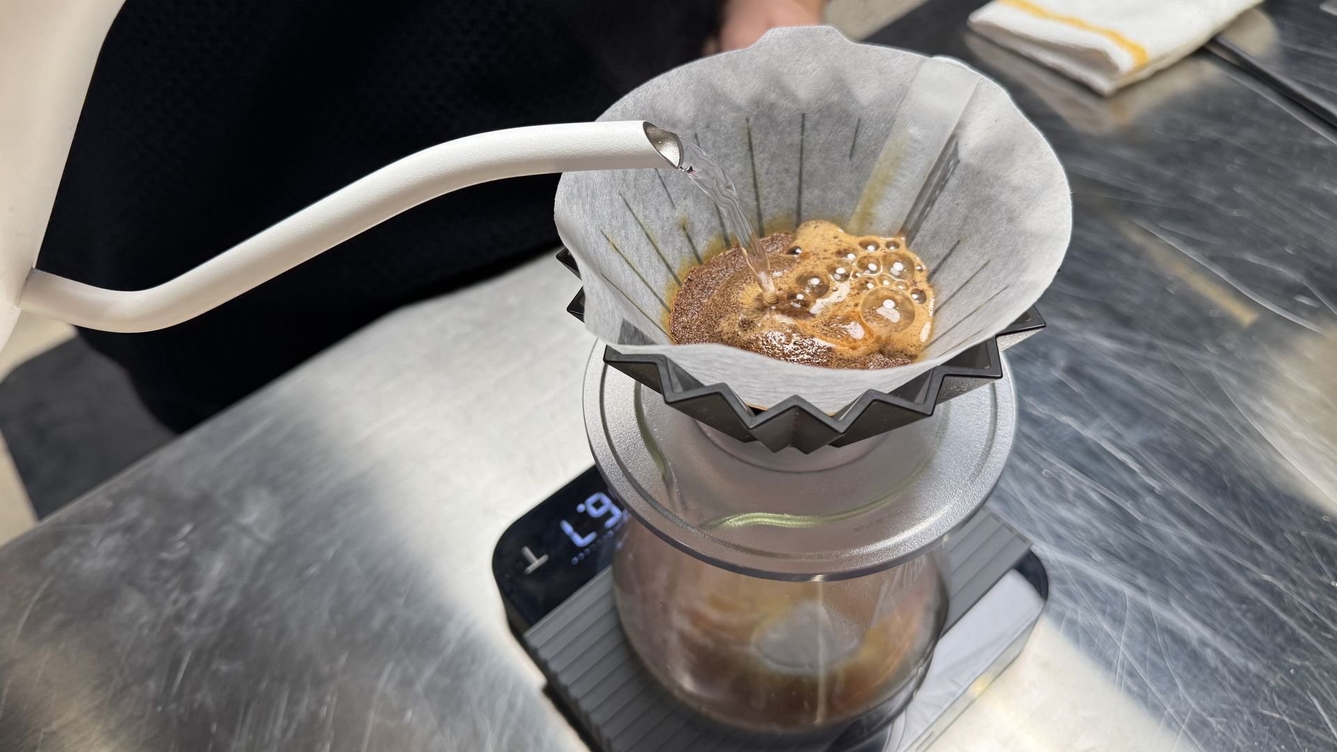 A photo of a kettle doing a pour over coffee.