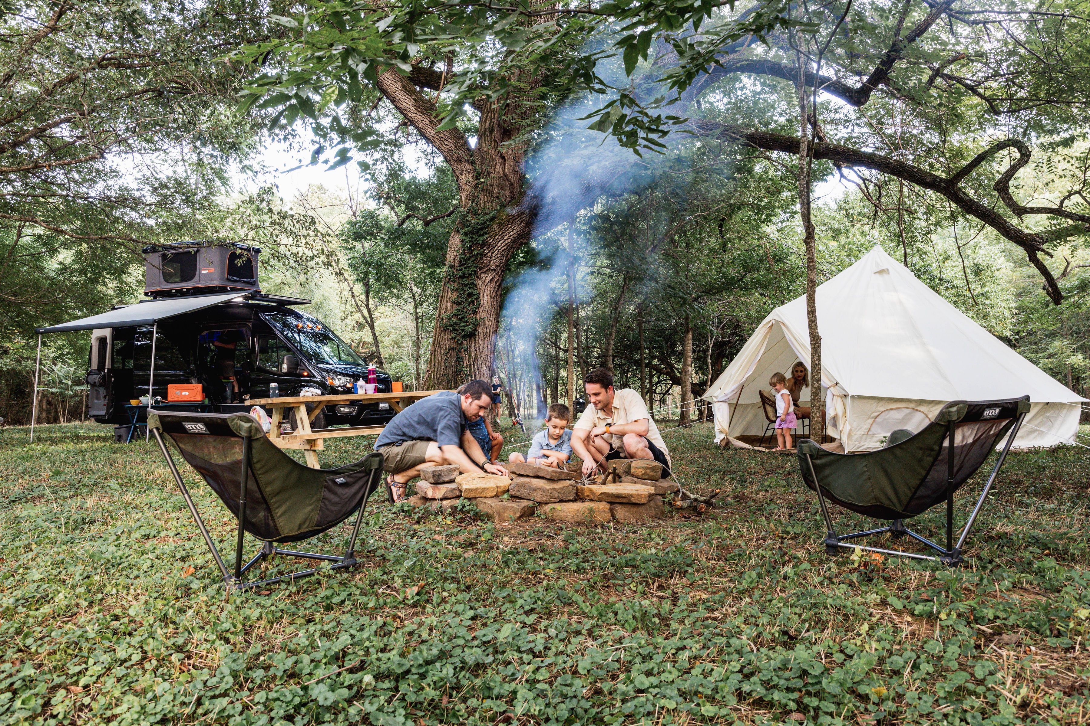 Photo of a family around a campfire.