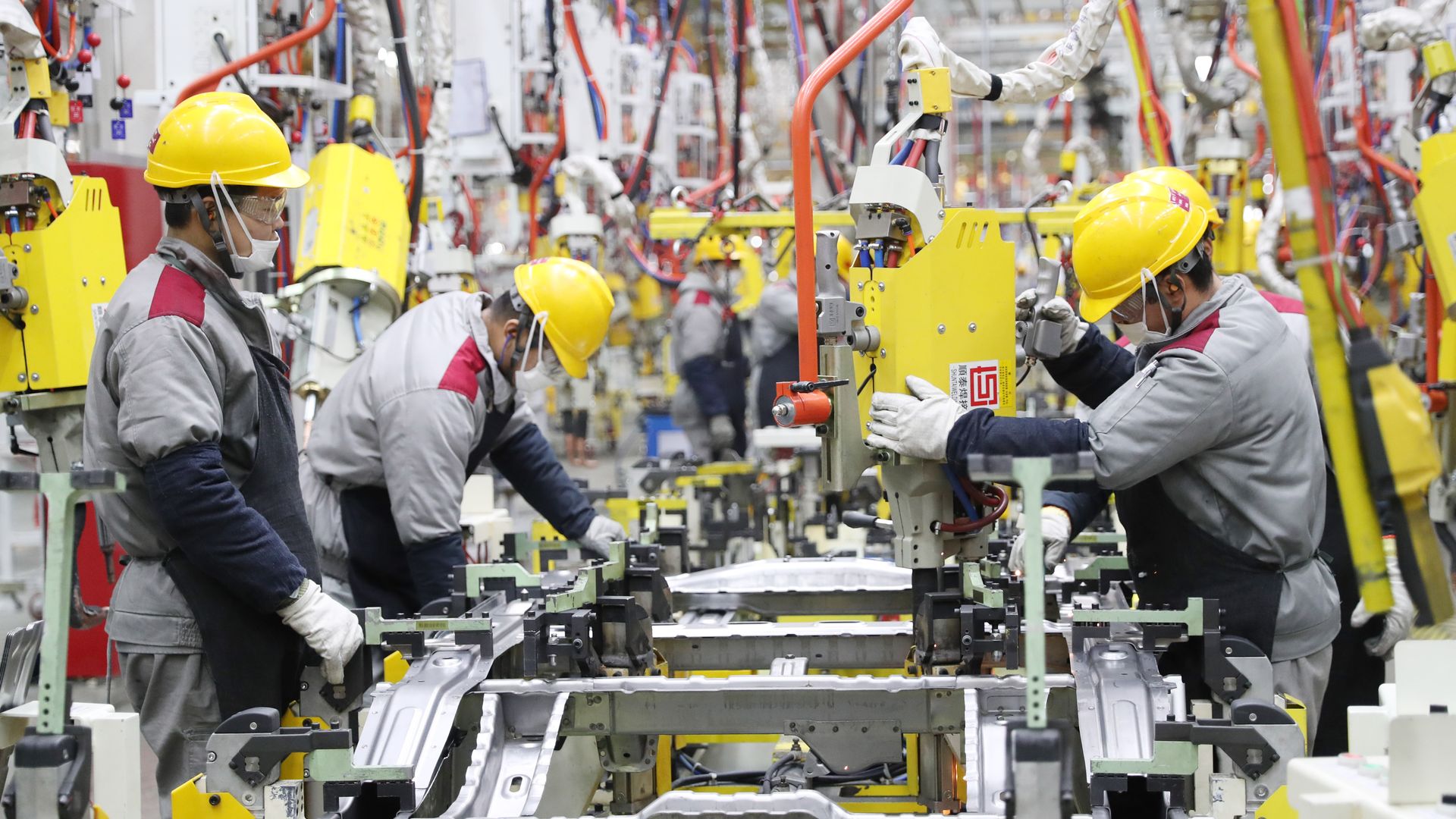 Employees work on the assembly line of vehicles at a factory of Beijing Automobile Works (Qingdao) Co., Ltd. on January 14, 2023 in Qingdao, Shandong Province of China. 