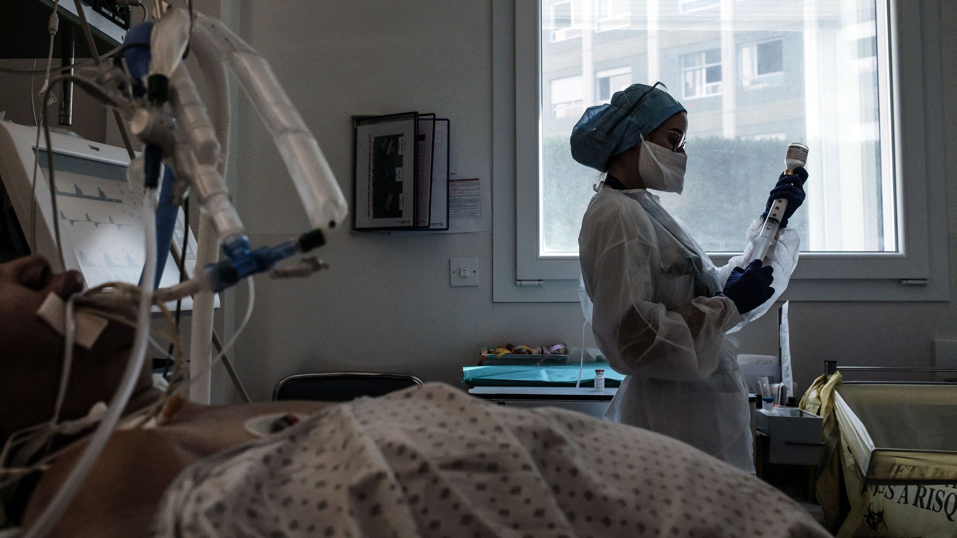 Photo of a nurse taking care of a patient in a hospital room
