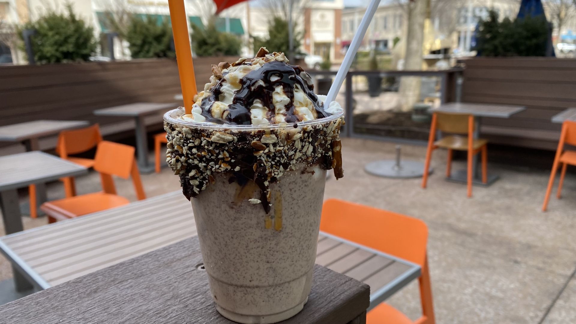 A chocolate milkshake topped with whipped cream and chocolate drizzle