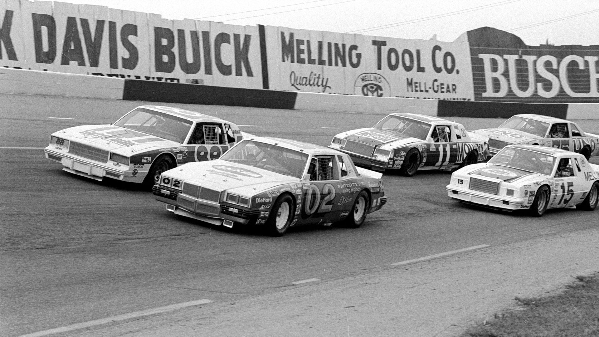 Four NASCAR cars zoom down the track the Nashville International Raceway on the Tennessee State Fairgrounds in Nashville, Tennessee in a 1981 race. 