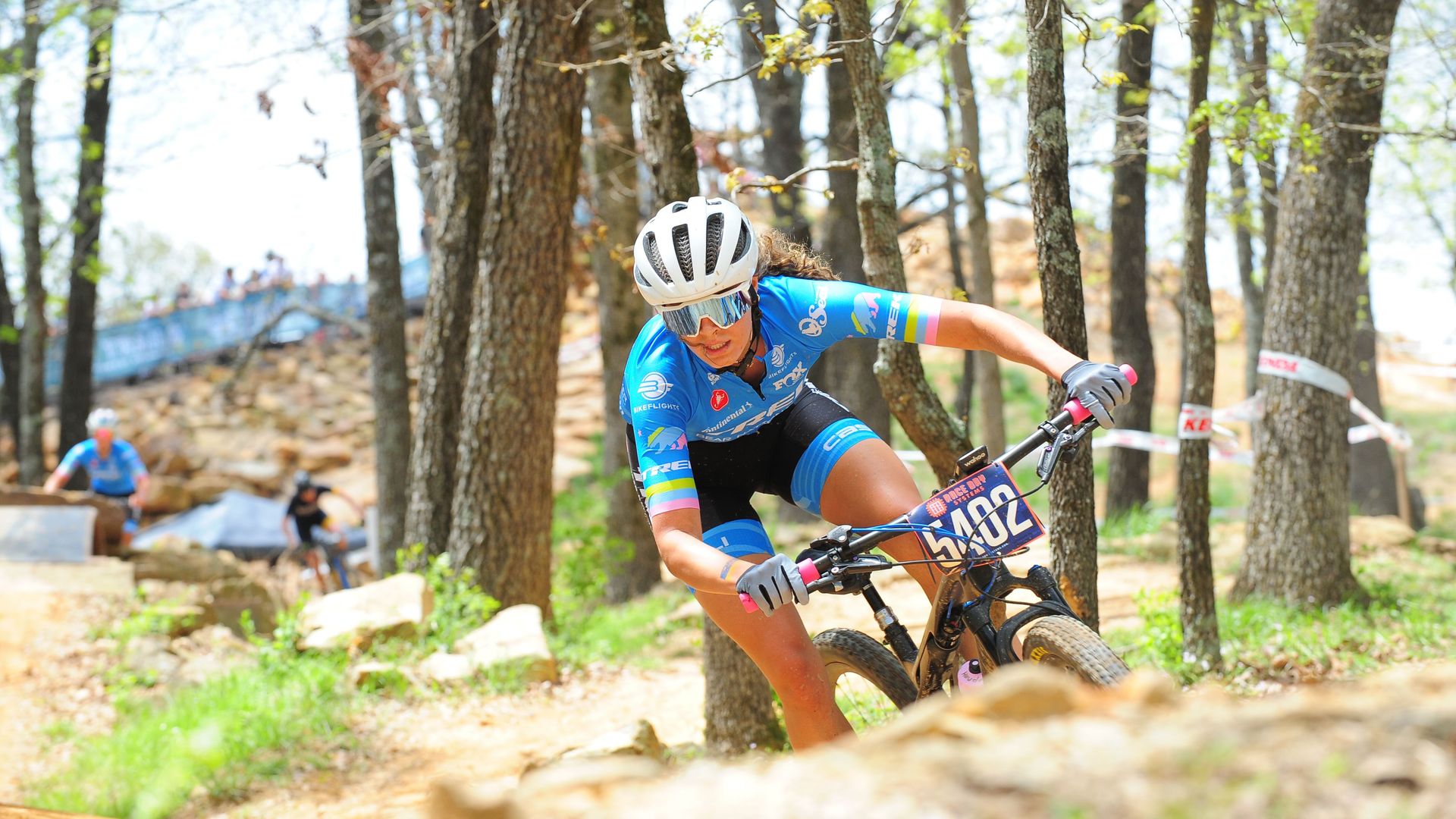 A woman mountain biker takes a turn.