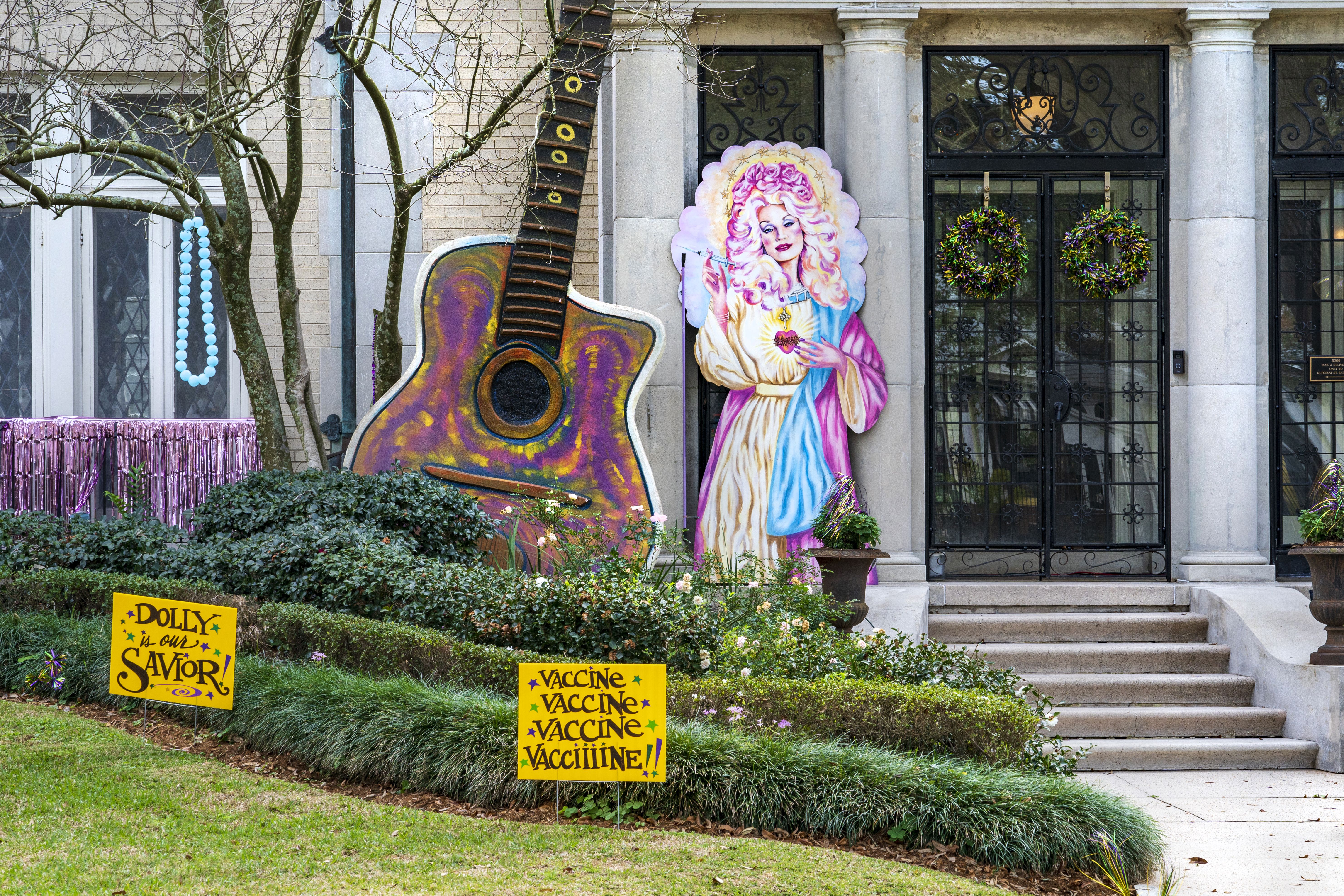 Image shows a house with an illustration of Dolly Parton as a multi-colored saint.