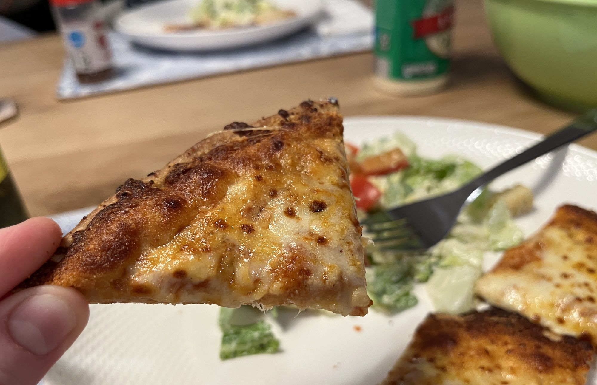 Triangle piece of cheese pizza.