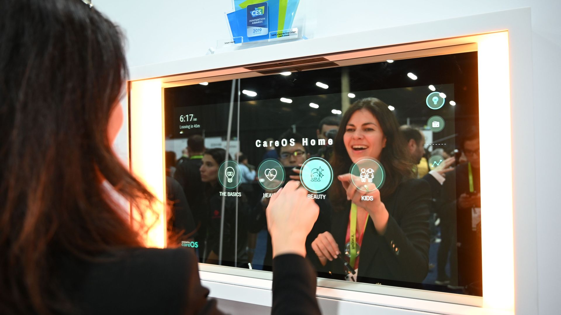 A woman looks in a smart mirror