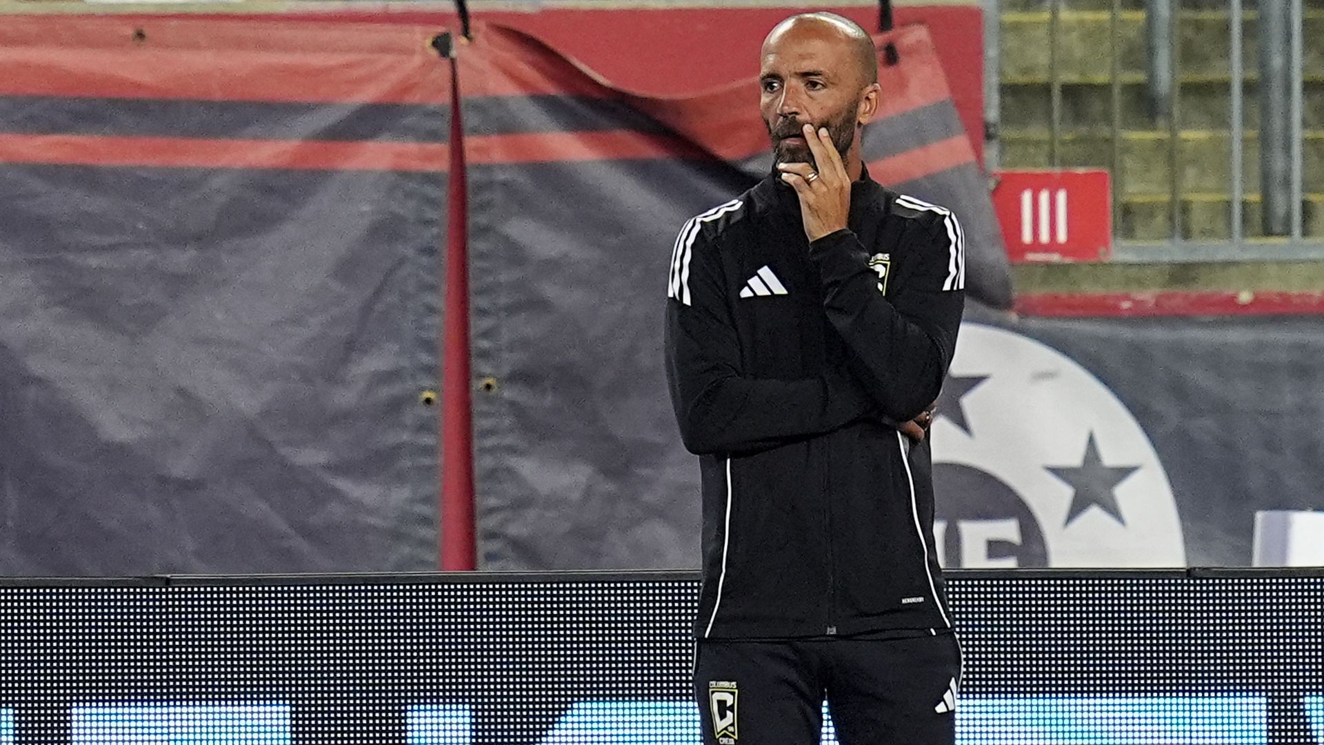 Crew 2 head coach Federico Higuaín stands with his arms folded watching a match.