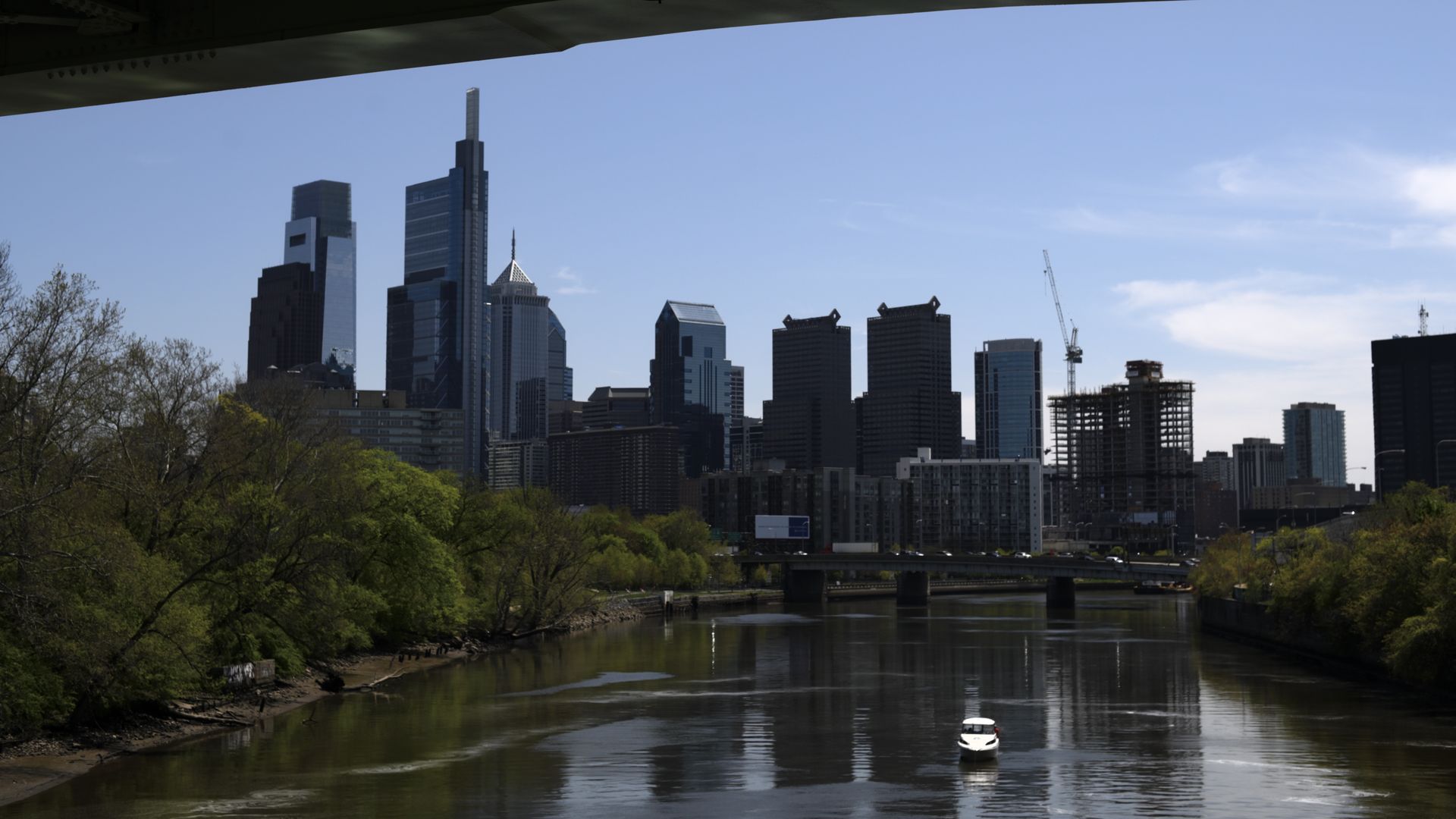 A photo of the Schuylkill River with the Philadelphia skyline in the background.